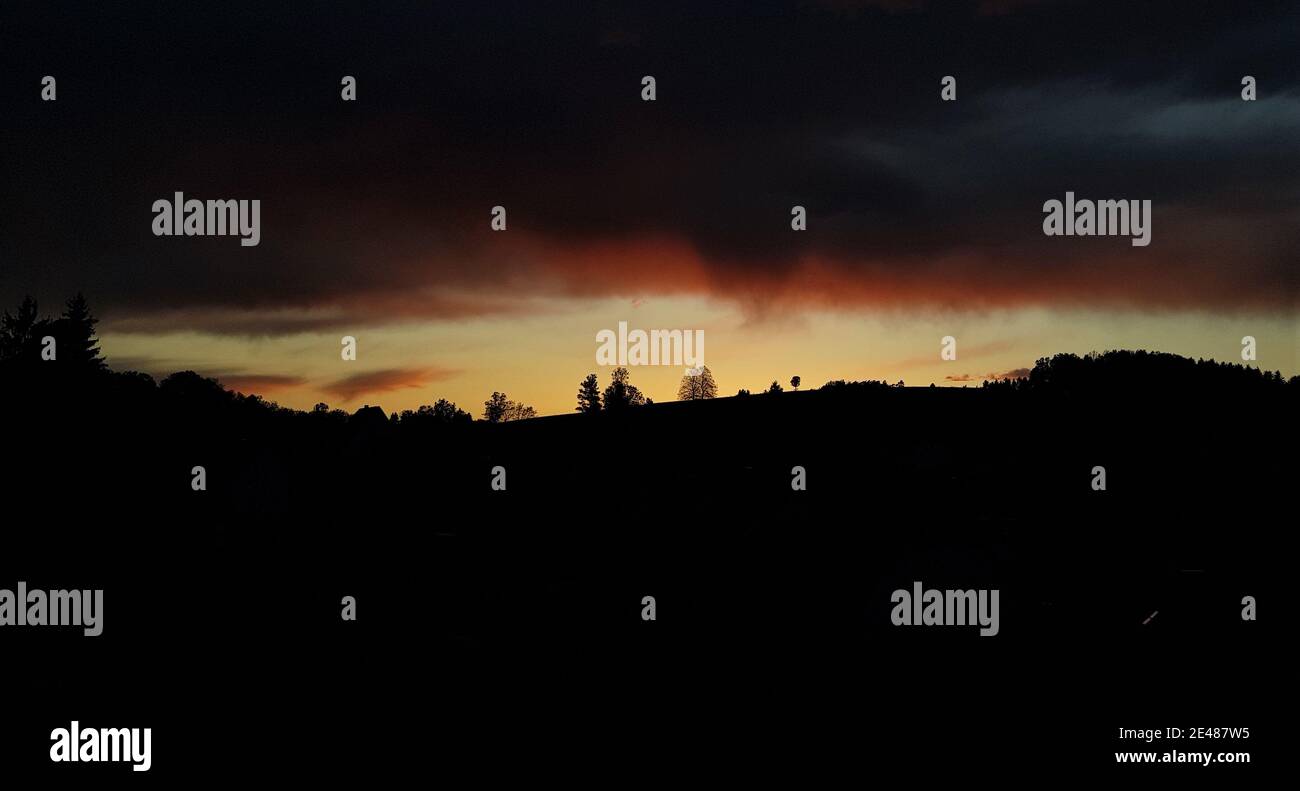 Sunset with dark storm clouds Stock Photo