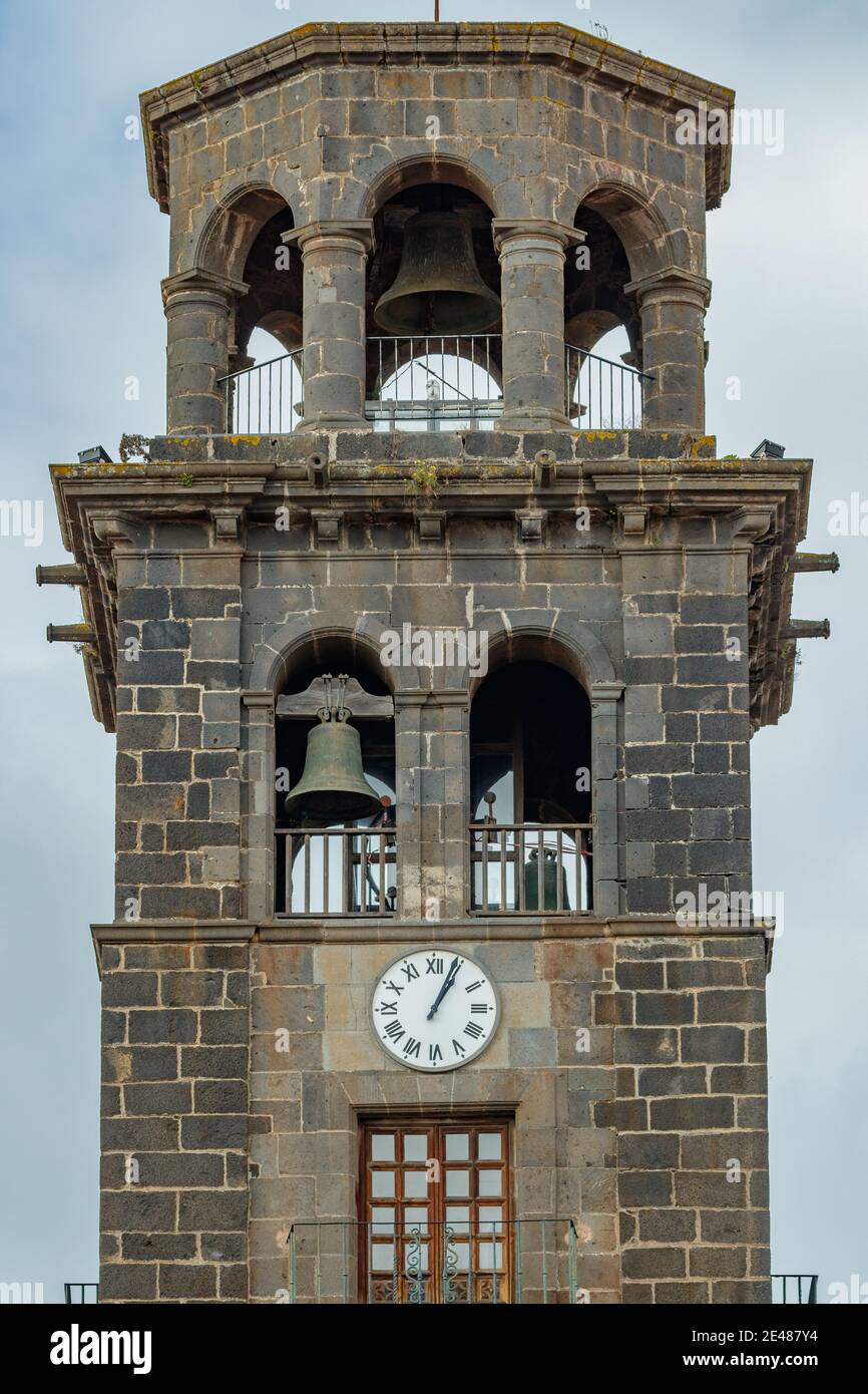 Bell tower with big clock on the wall in Church of the Immaculate