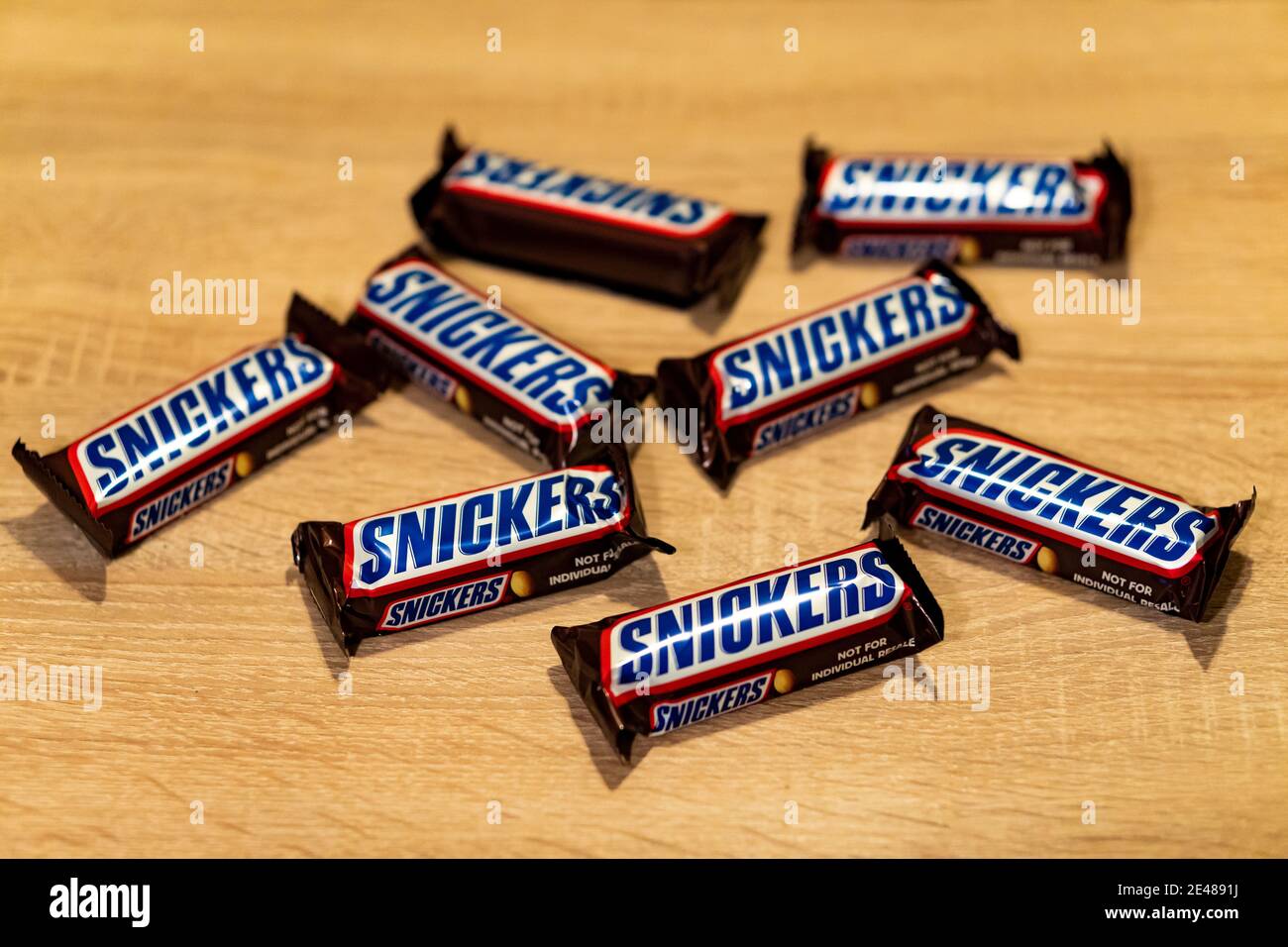 Snickers Pool Table POZNAN, POLAND - Jan 21, 2021: Snickers chocolate bar on a wooden table ...