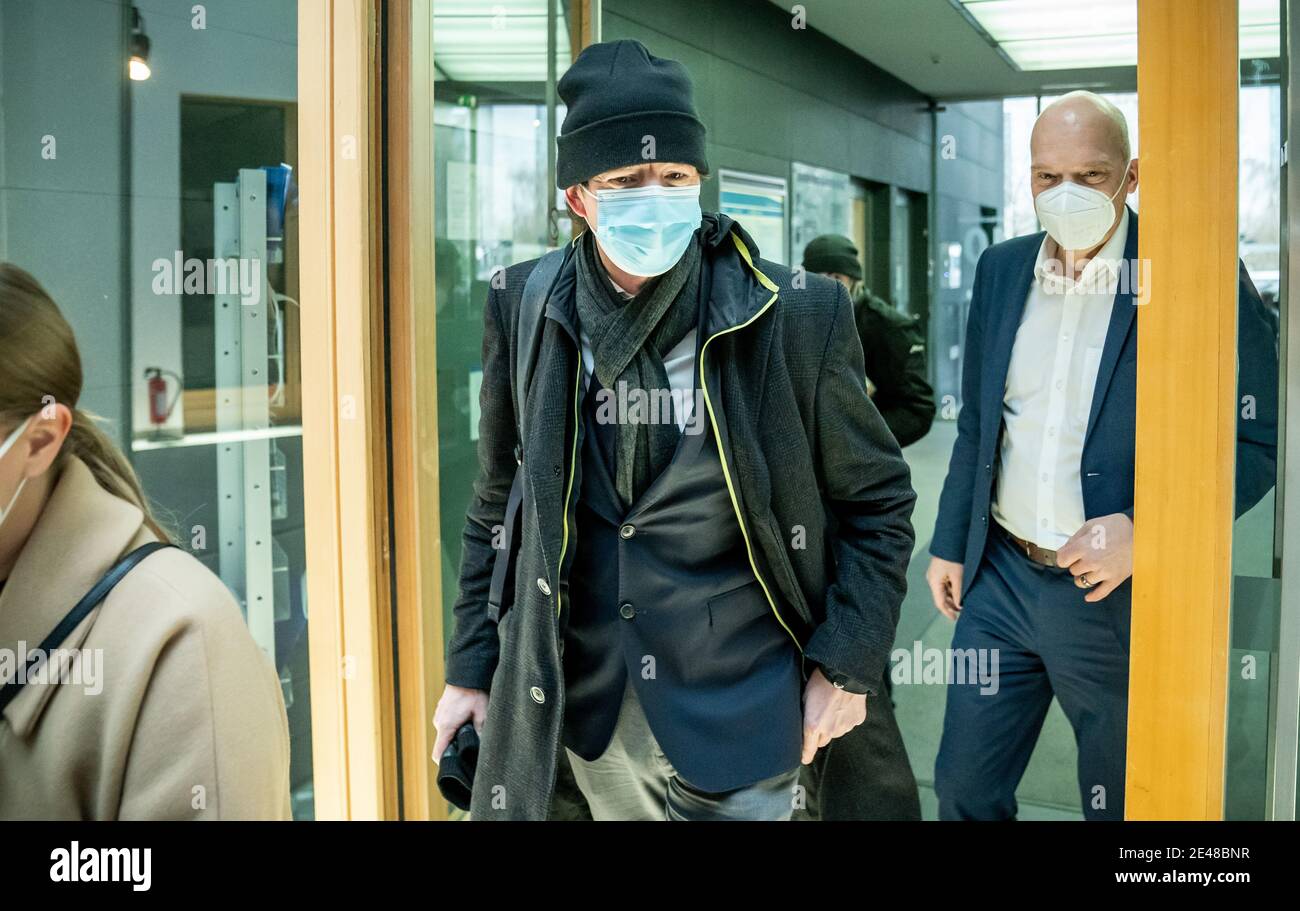 22 January 2021, Berlin: Christian Drosten (M), Director of the Institute of Virology, Charité Berlin, arrives with mask, cap and jacket for a press conference on the current situation at the Haus der Bundespressekonferenz. Photo: Michael Kappeler/dpa Pool/dpa Stock Photo