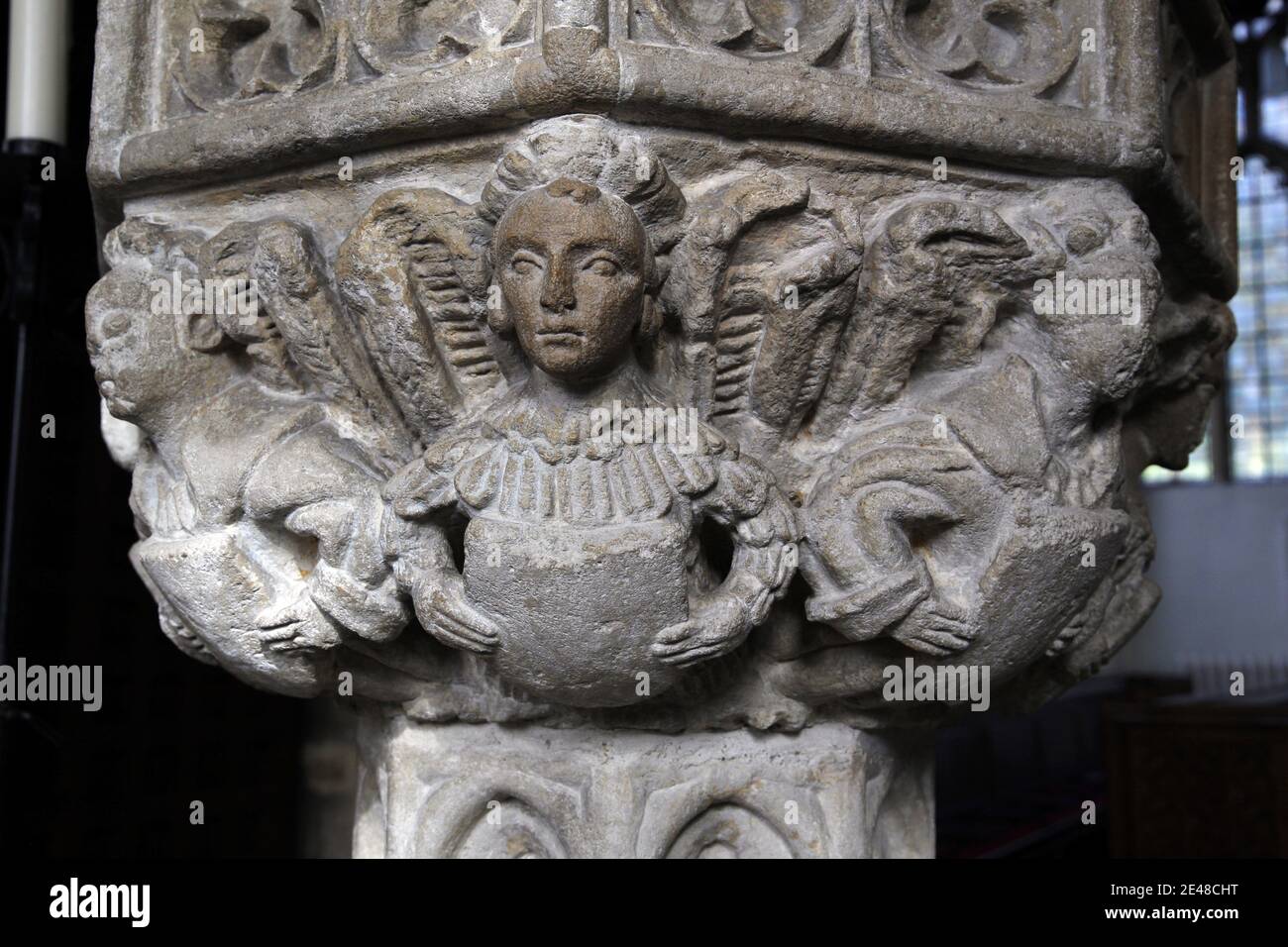 Detail of carved angels on the 15th century font at St John the Baptist Church, Axbridge, Somerset Stock Photo