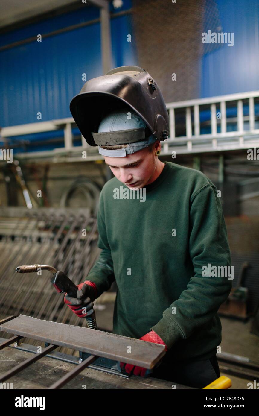 Welder at work getting ready for welding in workshop. Welder in his workshop. Stock Photo
