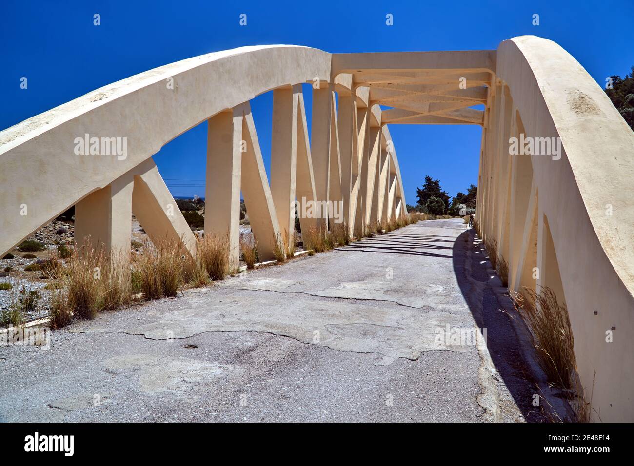 A road arched bridge over a dried river on the island of Rhodes Stock Photo