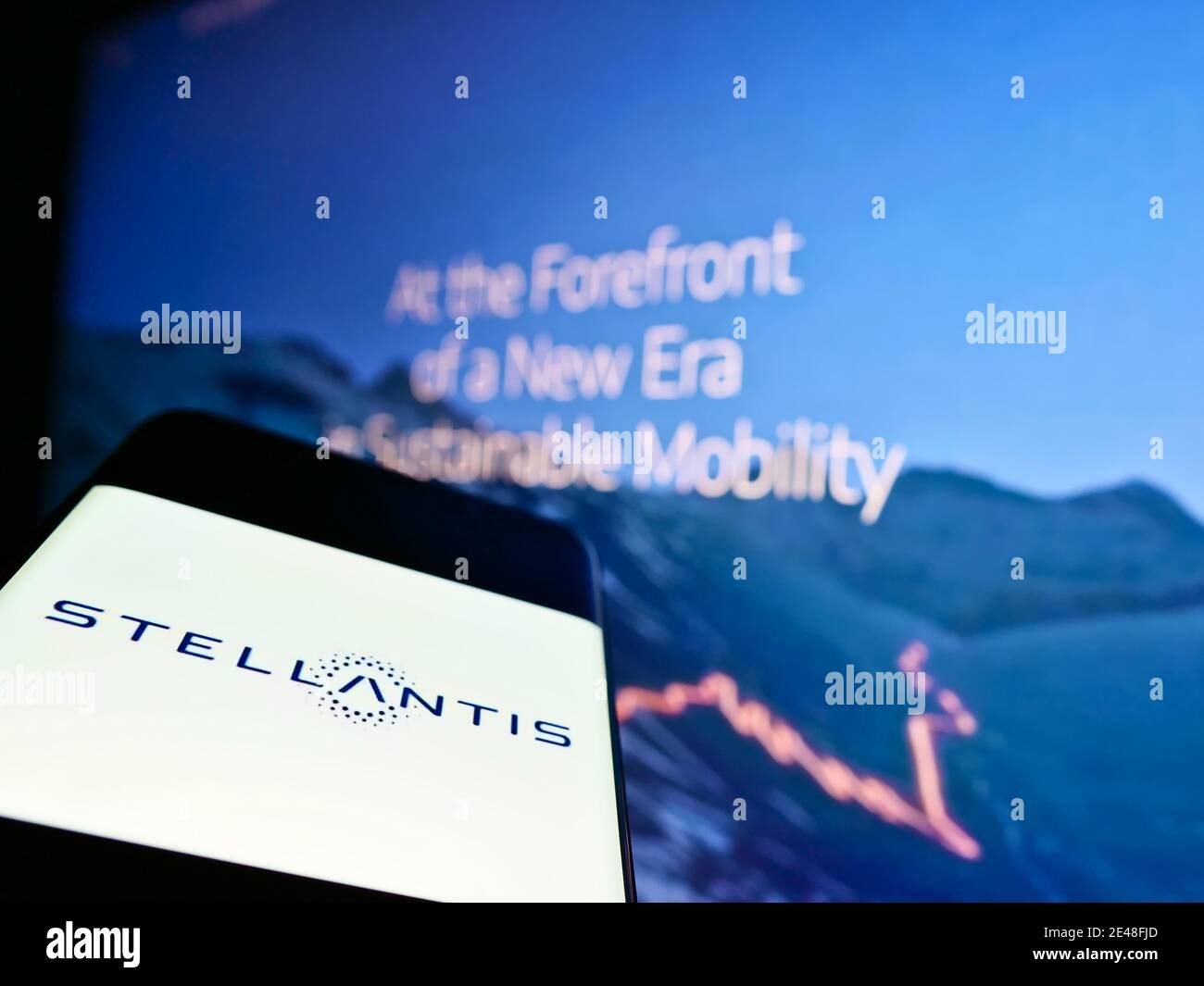 Mobile phone with logo of automotive company Stellantis N.V. on screen in front of company website. Focus on center of smartphone screen. Stock Photo