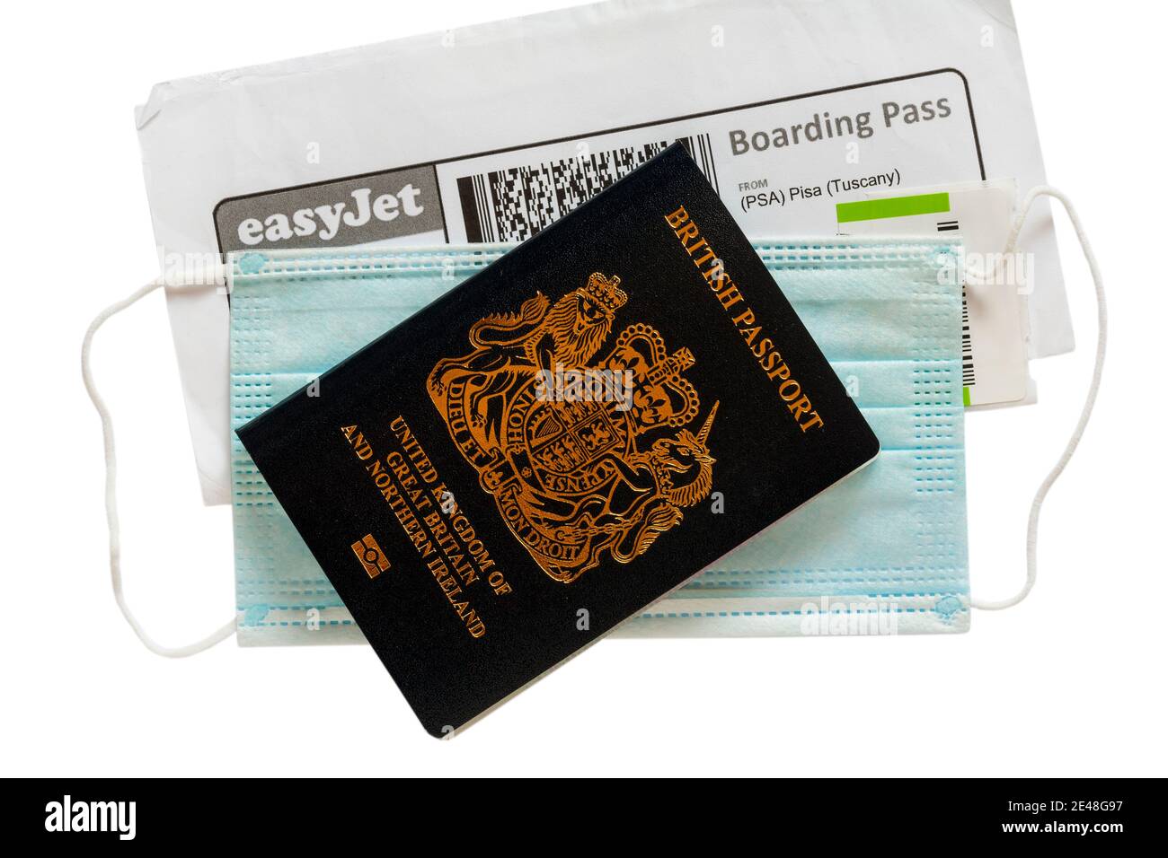 EasyJet boarding pass for flight from Pisa Tuscany and face mask with new British passport set on white background Stock Photo