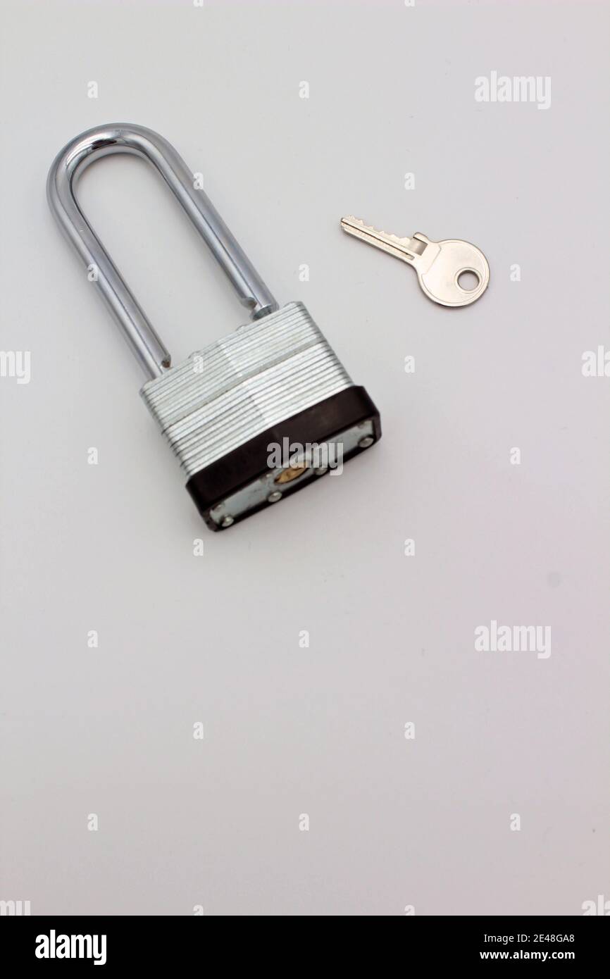 A steel padlock and key isolated on plain white background a concept of ...
