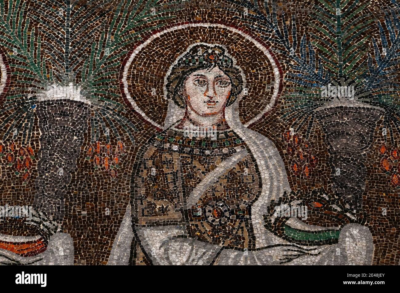 Bejewelled and sumptuously dressed female Christian Saint walks in