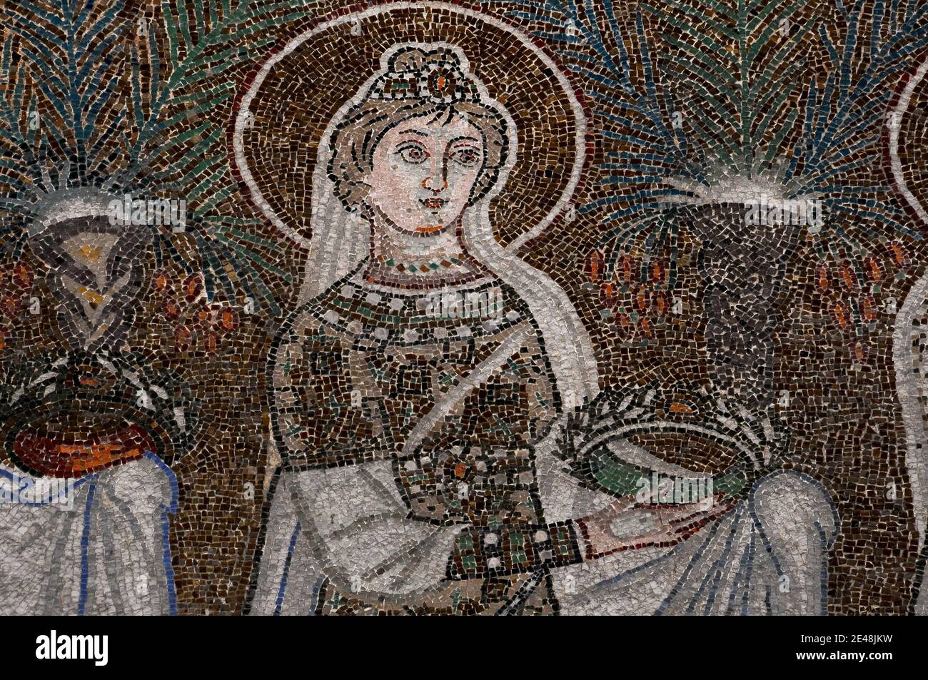 Bejewelled and sumptuously dressed female Saint walks in procession