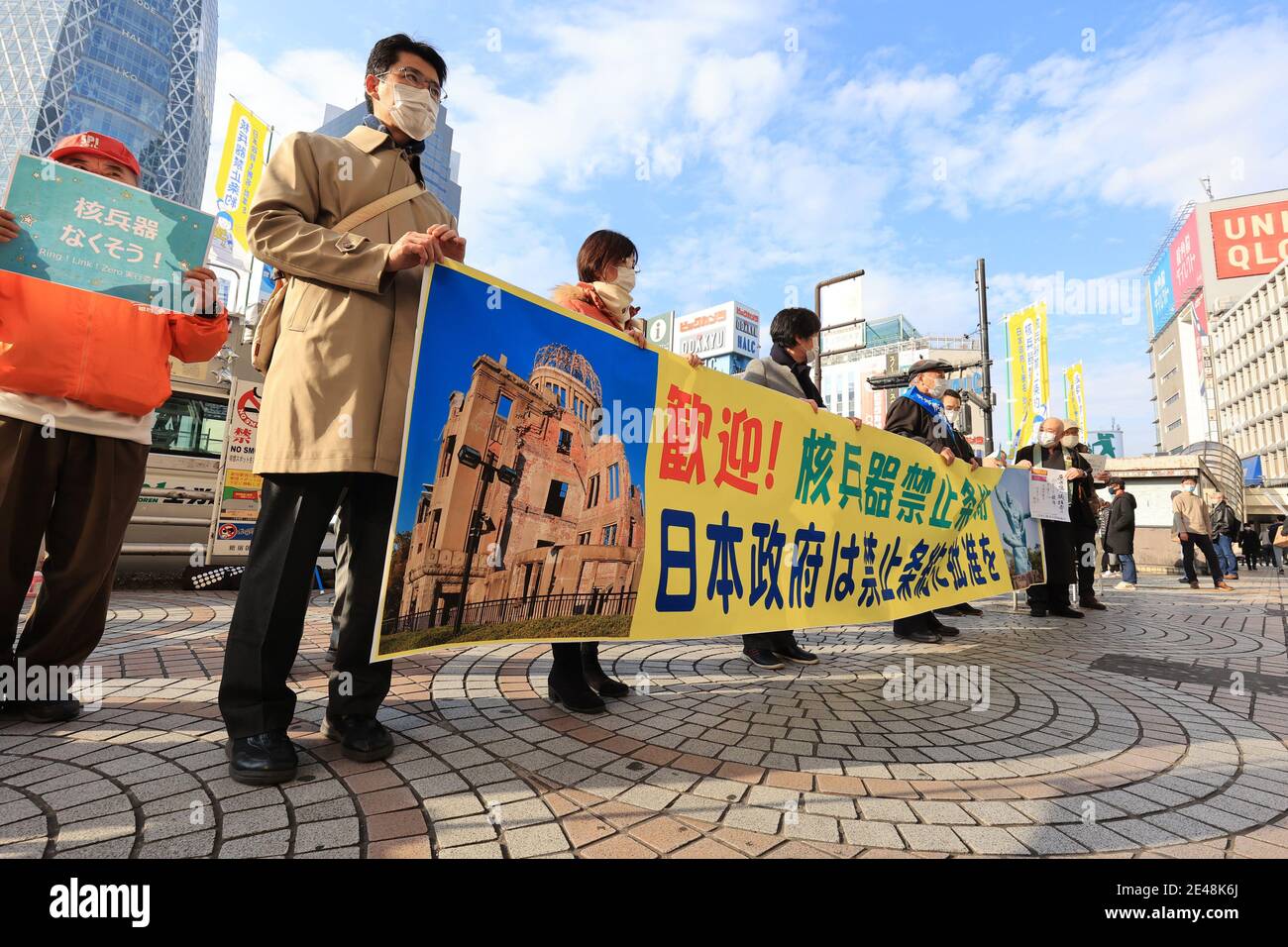 Tokyo, Japan. 22nd Jan, 2021. Antinuclear civic group members including A-bomb survivors (hibakusha) hold banners and placards to collect signatures for the petition to request Japanese government to ratify U.N. Treaty on the Prohibition of Nuclear Weapons in Tokyo on Friday, January 22, 2021. The treaty banning nuclear weapons set to enter into force on January 22 but Japanese government has not sign the treaty. Credit: Yoshio Tsunoda/AFLO/Alamy Live News Stock Photo