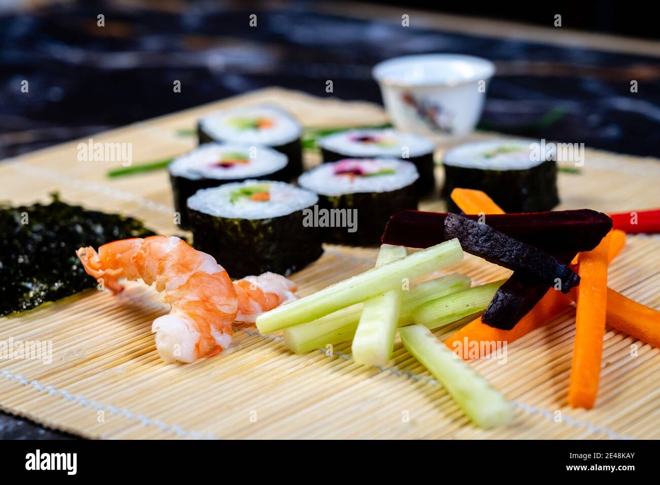 https://c8.alamy.com/comp/2E48KAY/homemade-sushi-traditional-japanese-master-making-healthy-maki-rolls-with-prawns-cucumber-carrot-fish-2E48KAY.jpg