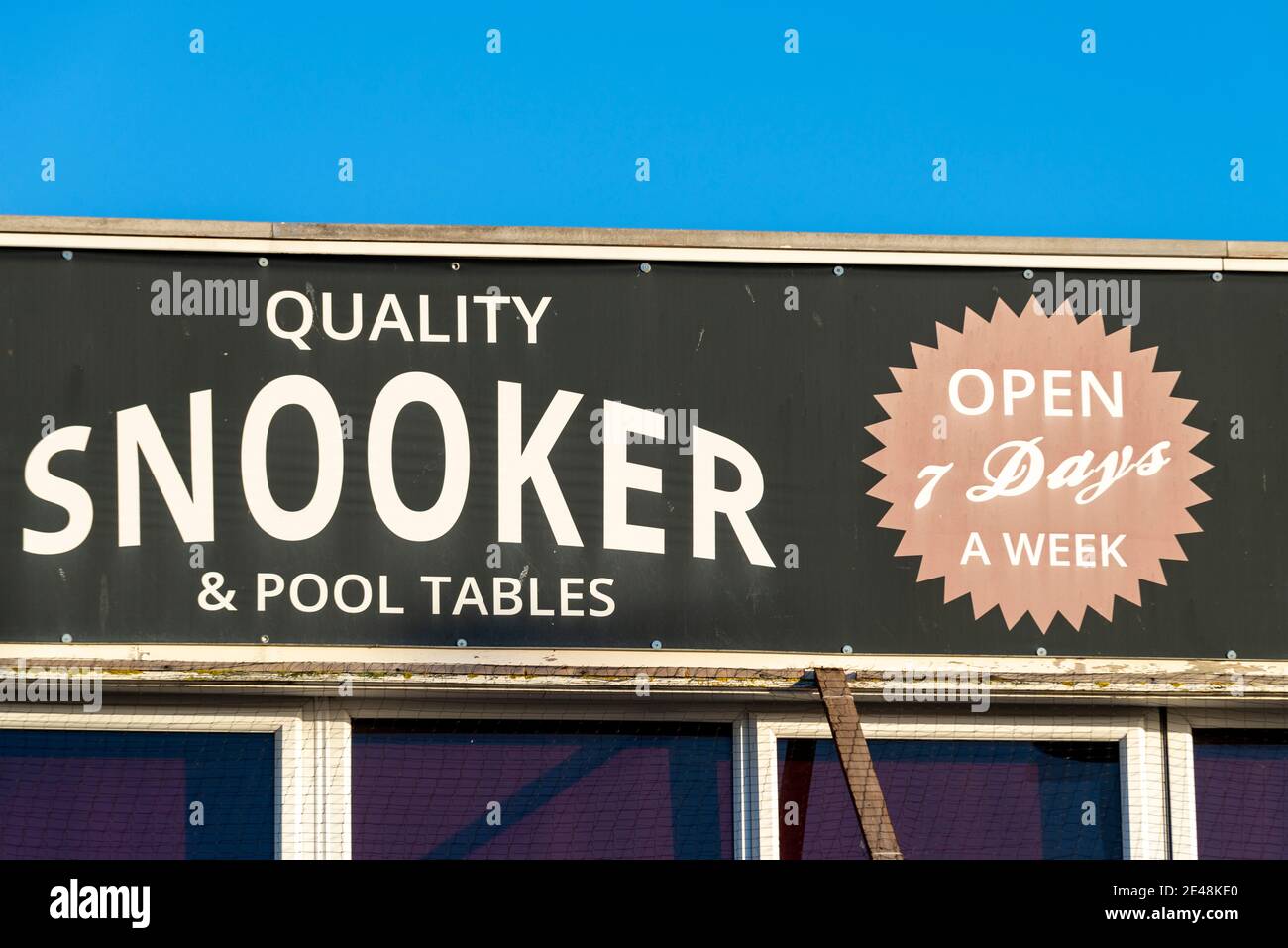 Snooker Hall above New York amusement arcade early in the morning on a sunny day on Marine Parade, Southend on Sea, Essex, UK. Blue sky Stock Photo