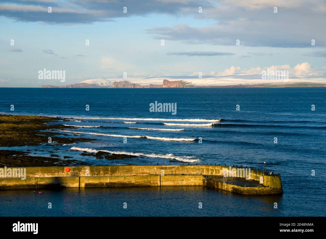 The hills of Hoy on Orkney, from Harrow harbour, Caithness, Scotland, UK Stock Photo