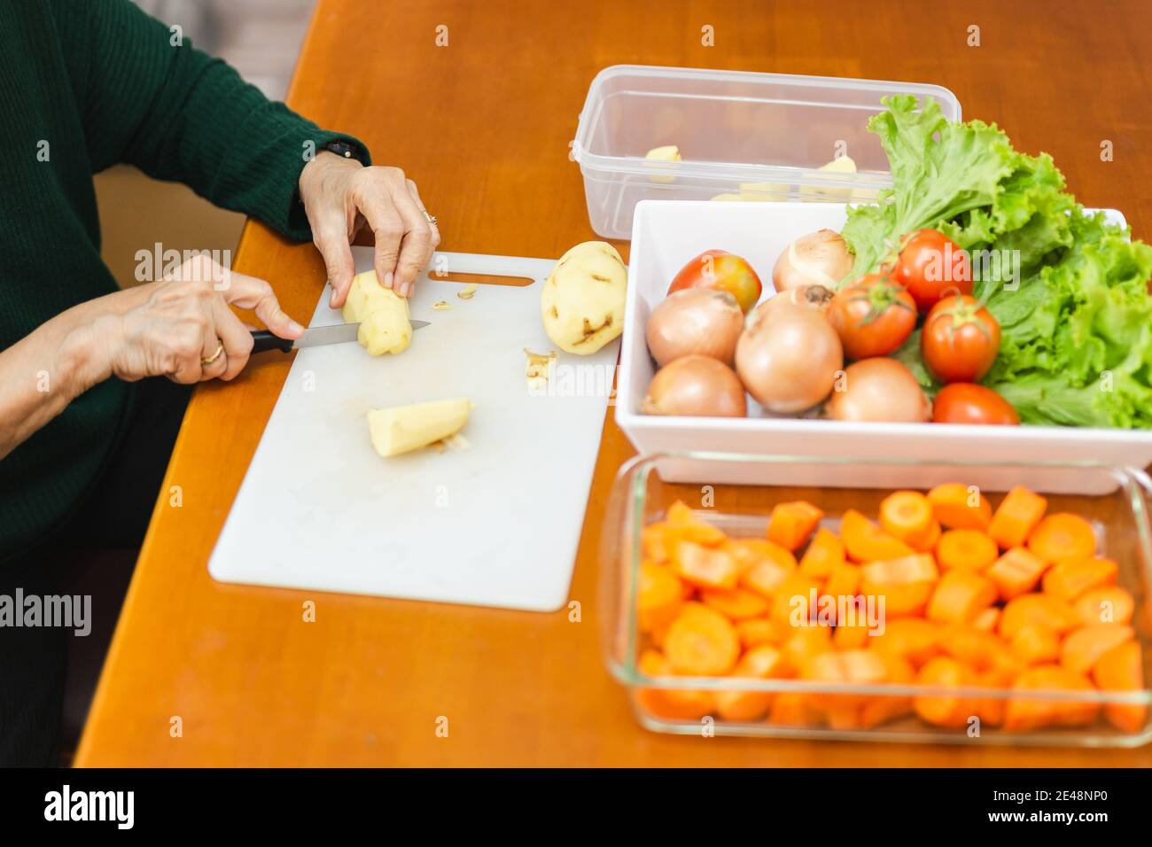 Woman peeling onion table hi-res stock photography and images - Alamy