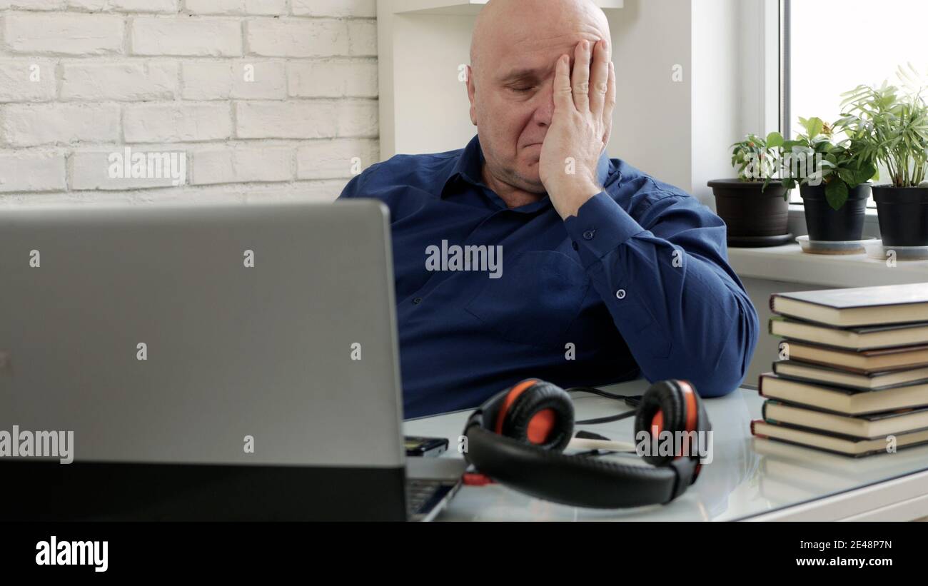 Man Working from Home Talking in a Video Call Using Laptop Connection Stock Photo