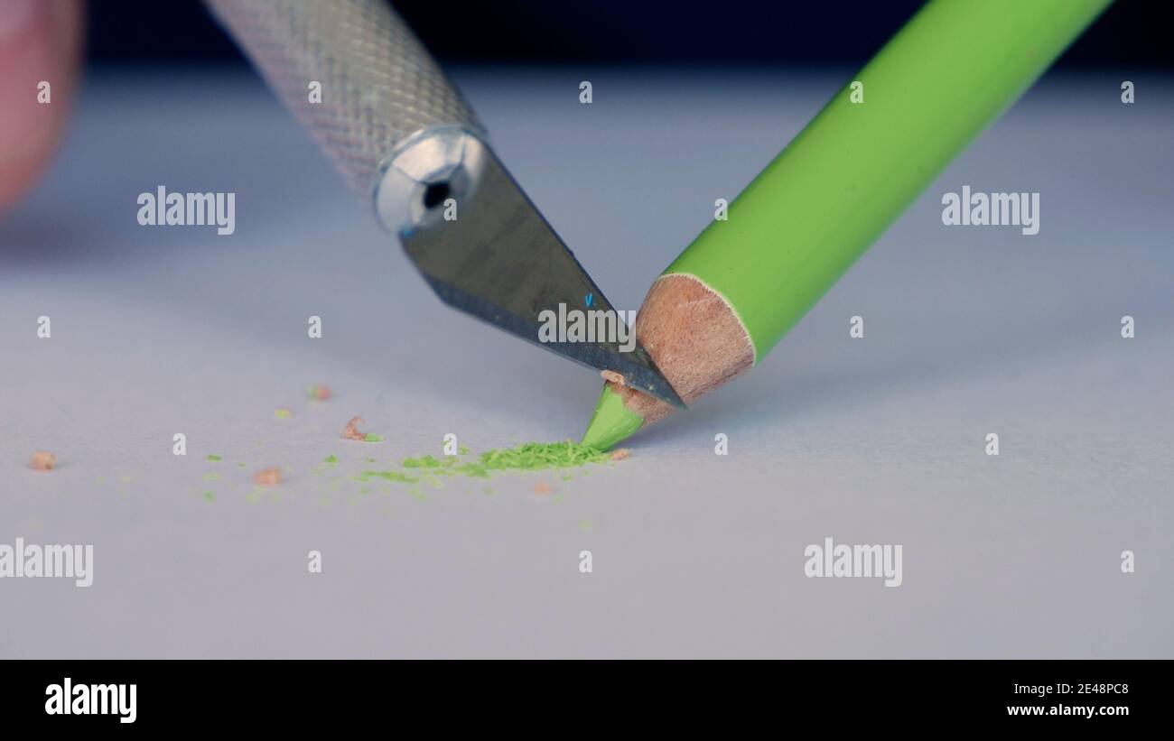 Elderly Person Sharpen a Colored Pencil Using a Sharp Little Knife