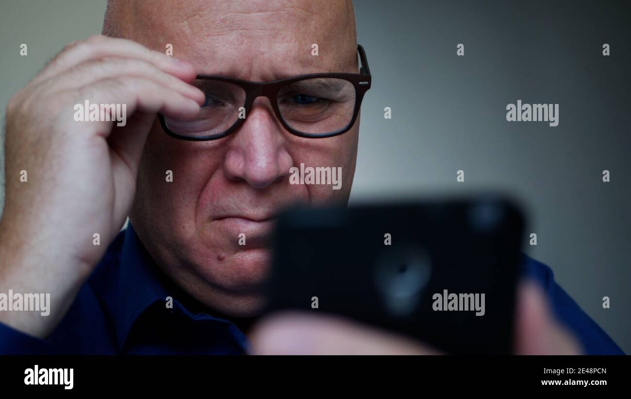 Businessman Texting a Message Using a Cellphone, a Person Accessing Social Media Stock Photo