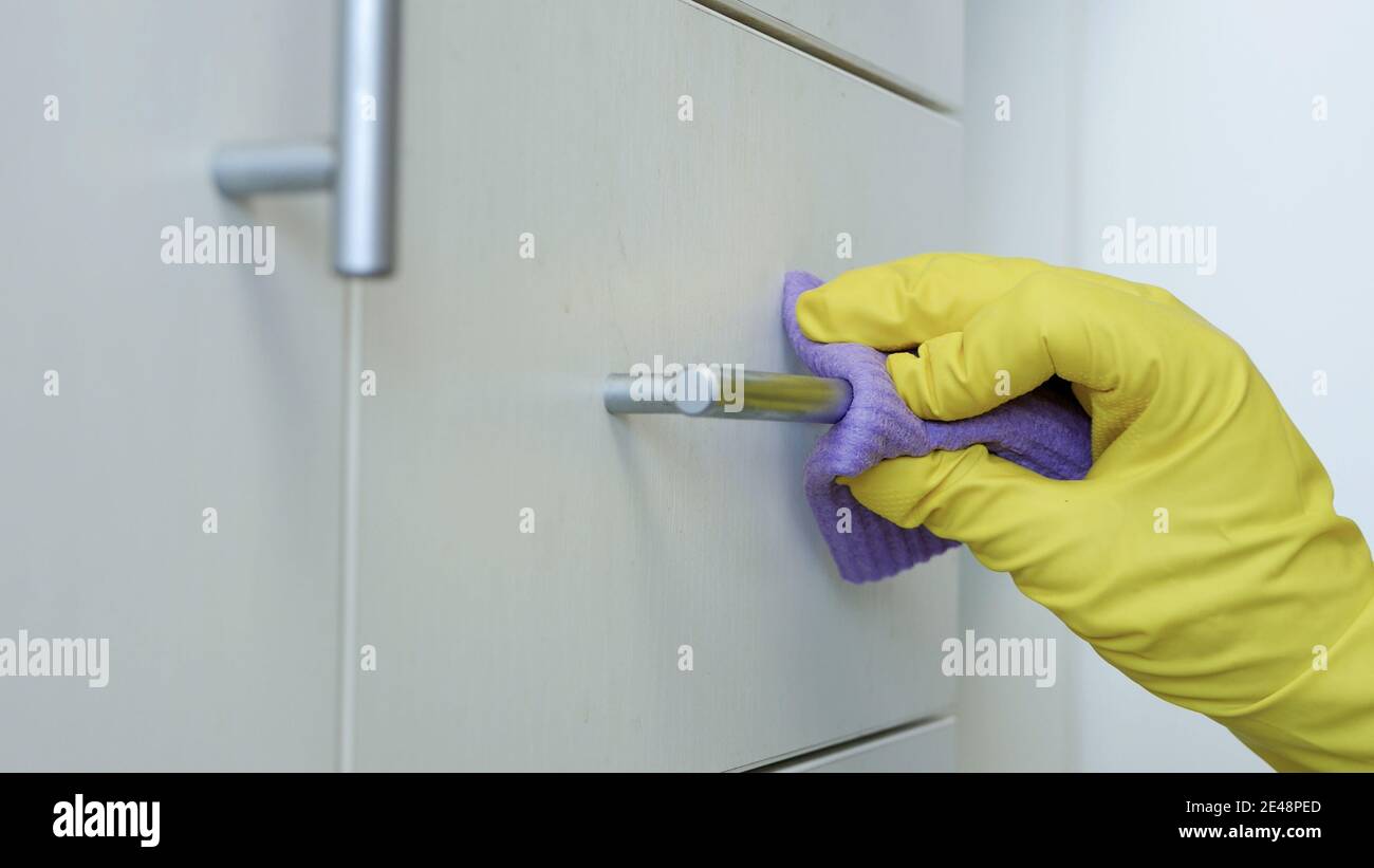 Closeup Man Hands Wearing White Protective Household Gloves Cleans and Disinfects Kitchen and Bathroom Furniture Stock Photo