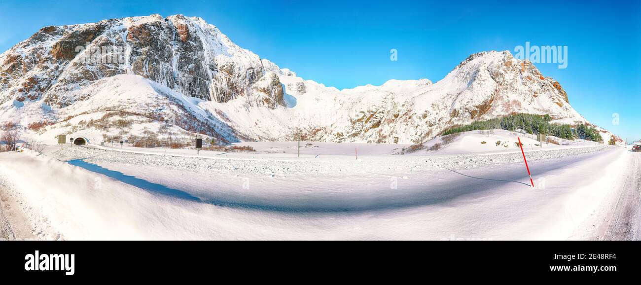 Fabulous winter view of frozen Hamnoyvatnet lake and enterance to tunnel seen from  Akkarvikodden Reststop.  Location: Hamnoy, Lofoten; Norway, Europe Stock Photo