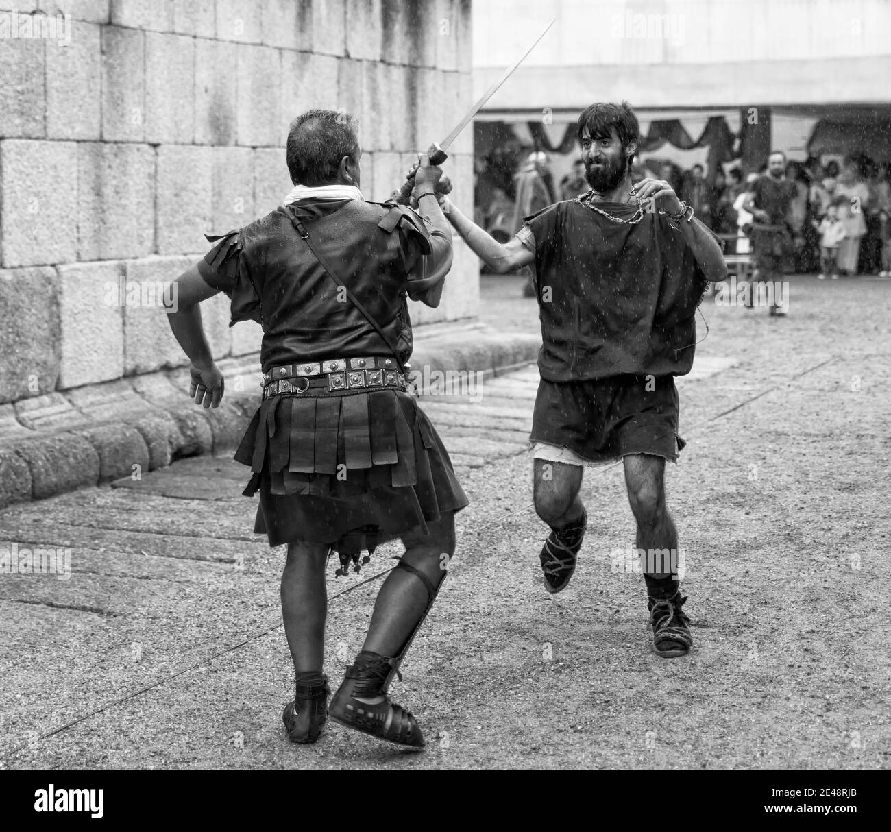 MERIDA, SPAIN - Sep 27, 2014: Two people dressed in costumes of Roman legionary and barbarian, participates in historical reenactment of wars against Stock Photo