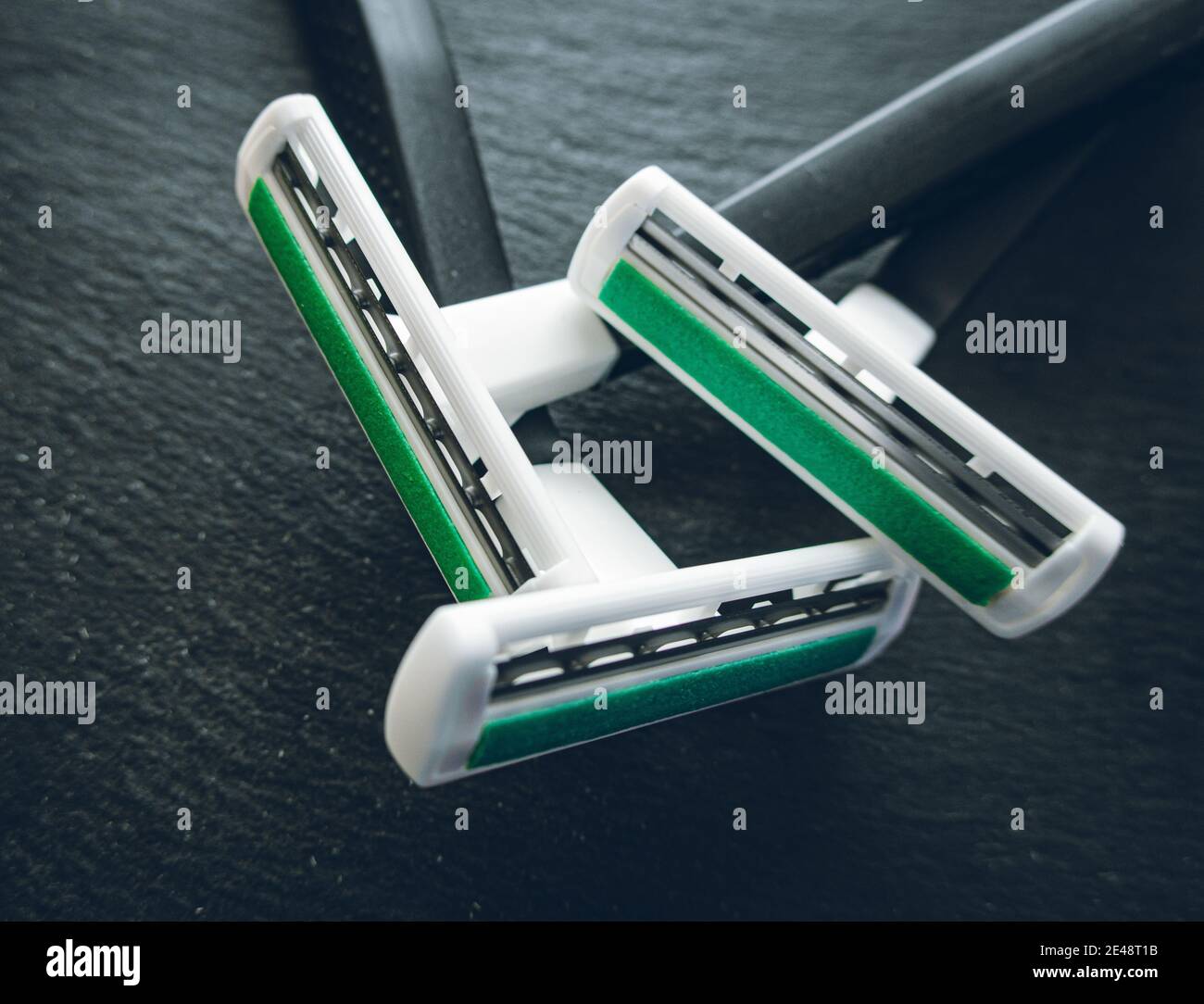 Razors, with lubricant on a black background Stock Photo - Alamy