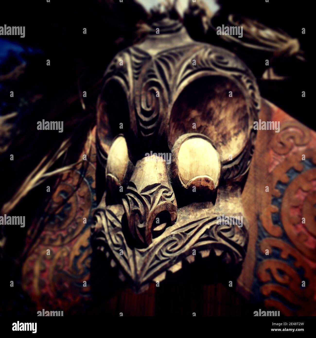ROTORUA, NEW ZEALAND - Jan 04, 2016: Scary warrior wooden Maori mask handcrafted. Stock Photo