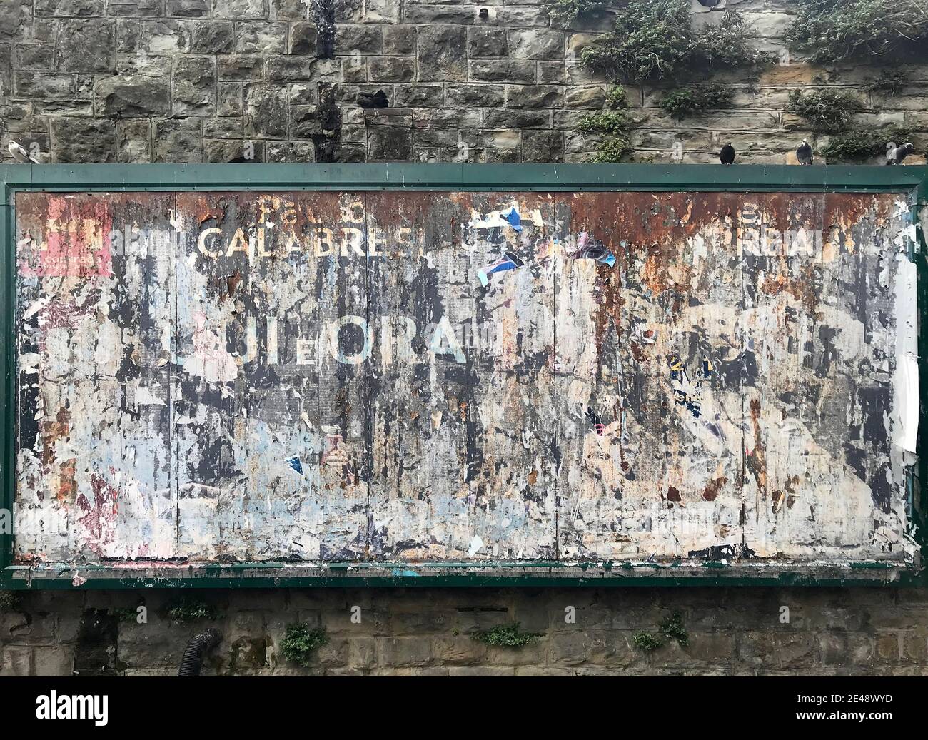 View of italian torn poster on billboard Stock Photo