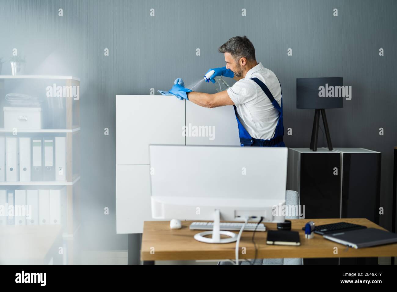Professional Janitor Office Cleaning Service. Man With Chemical Spray