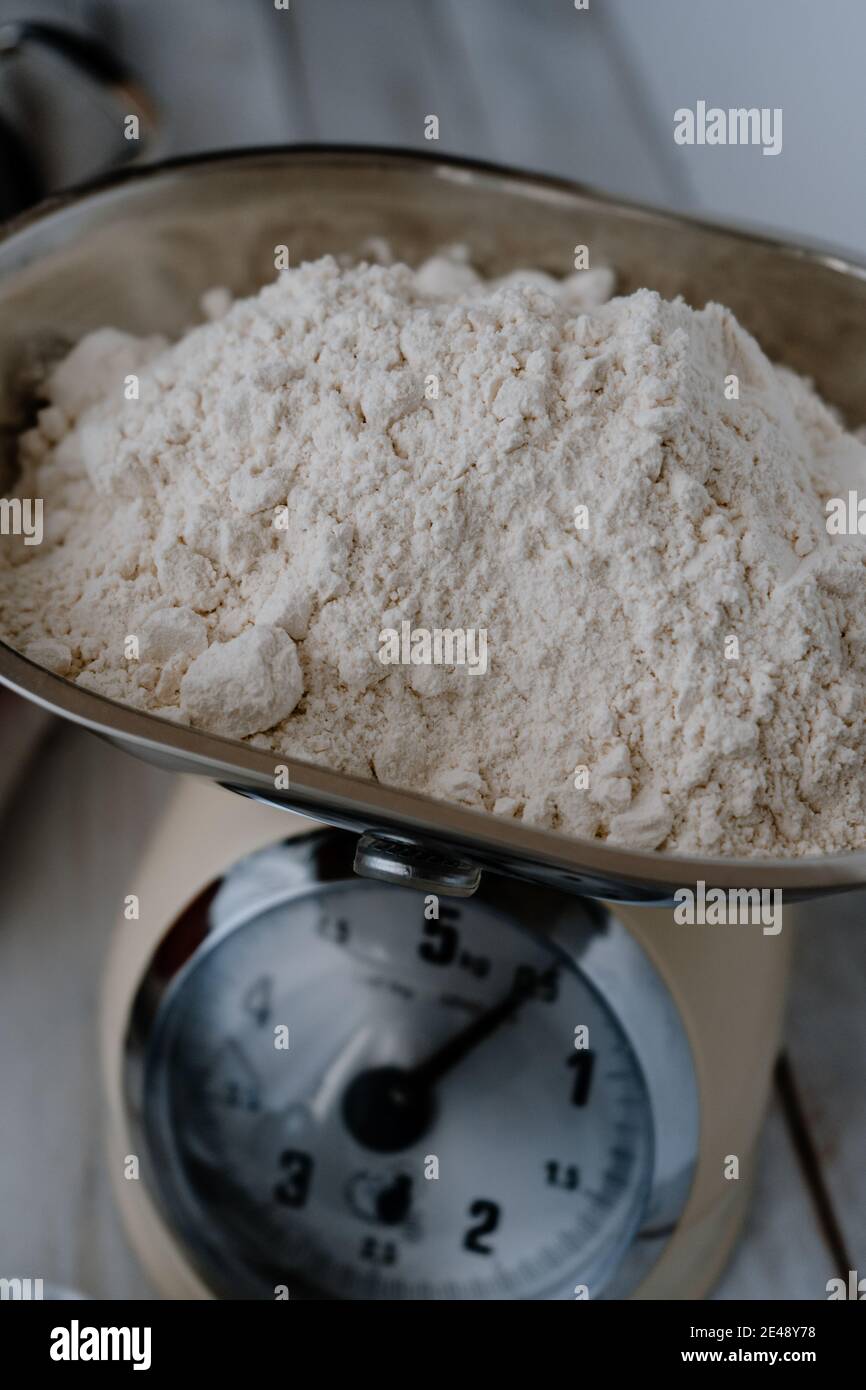 Wheat flour in a traditional balance weight. Closeup Stock Photo Alamy