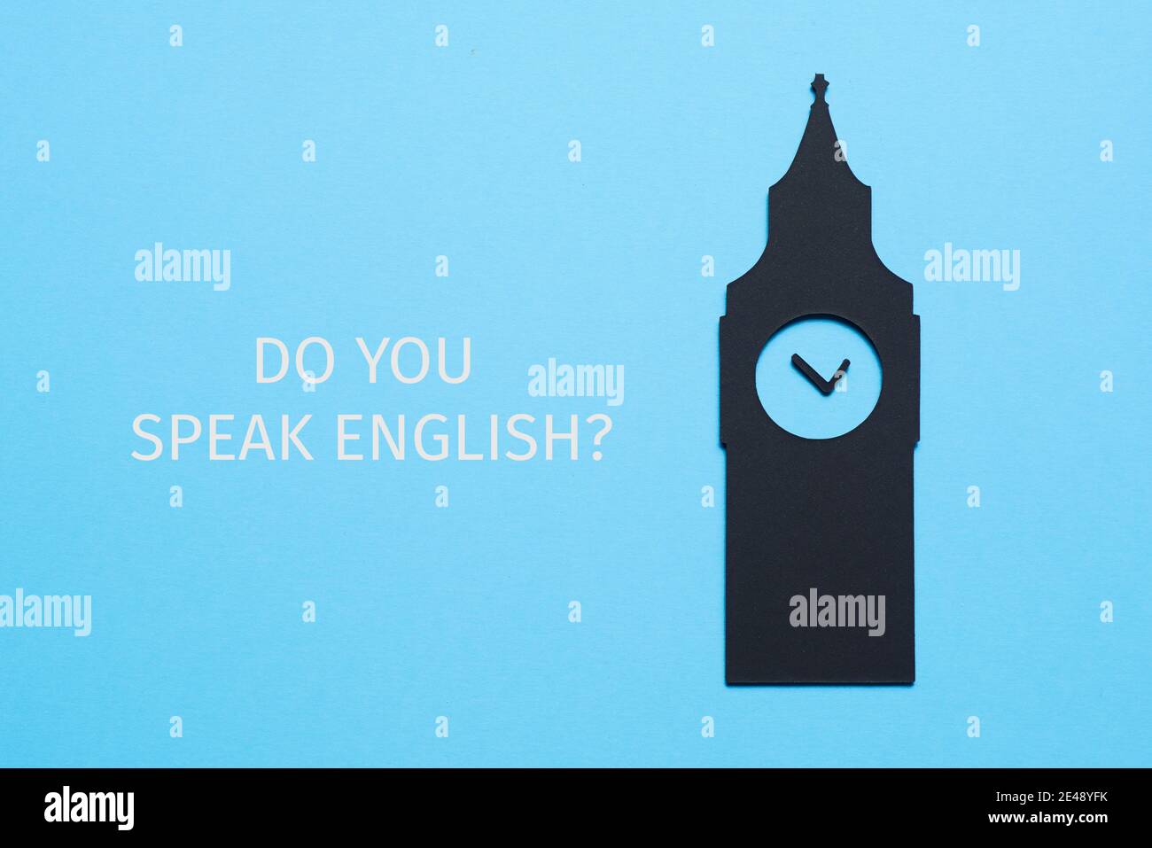the big ben, cutout on a black paperboard, and the question do you speak english written on a blue background Stock Photo