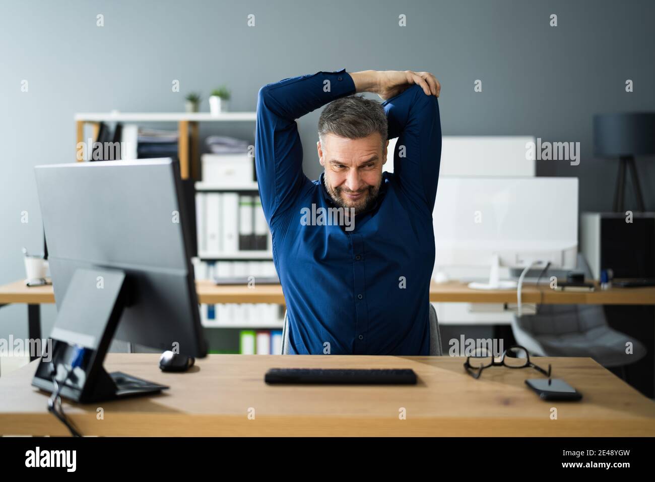 Stretch Exercise At Office Desk At Work. Stress Break Stock Photo Alamy