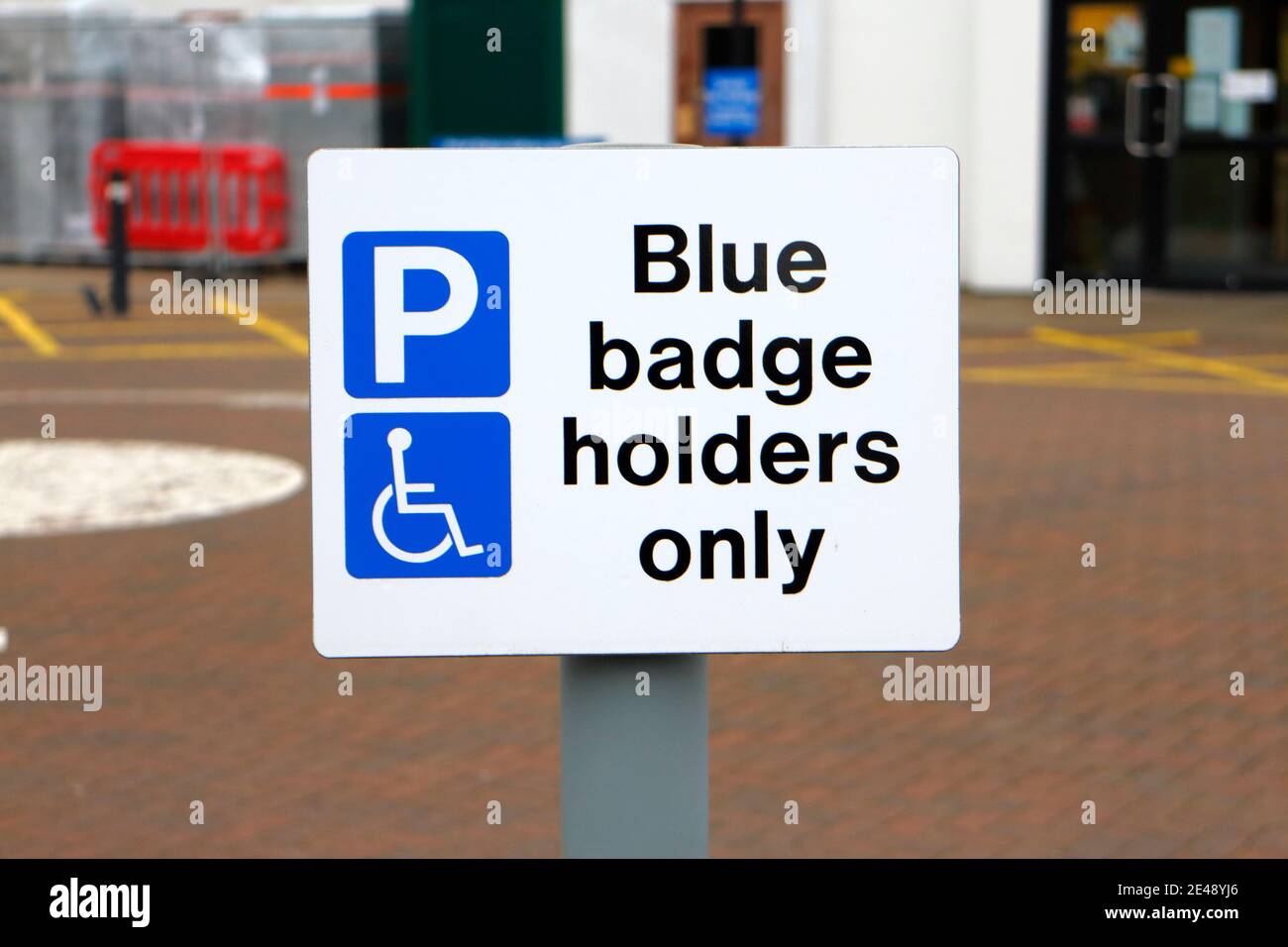 Car parking sign for Blue Badge Holders Only in the parking area for
