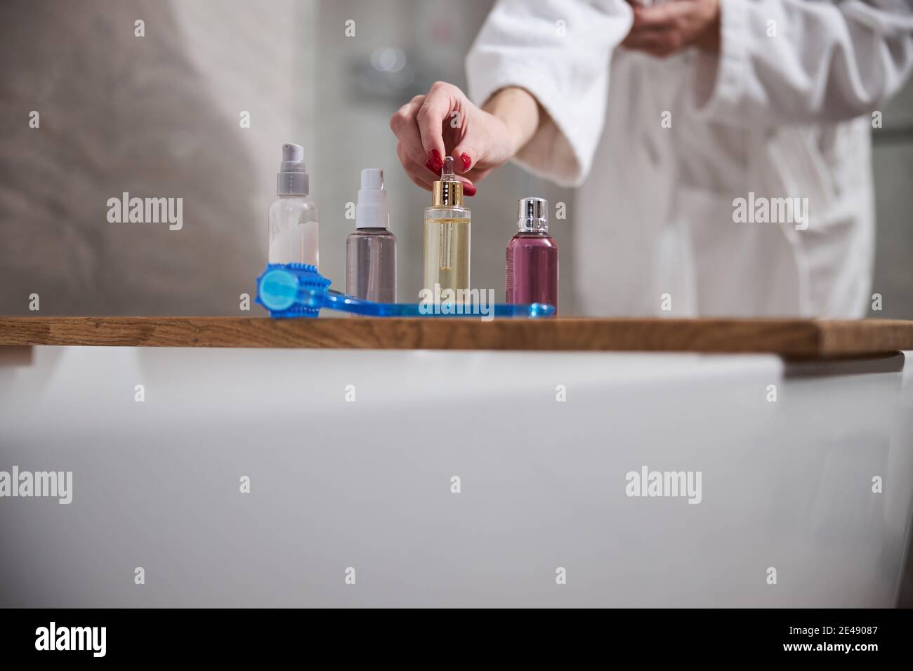 Cropped photo of lady arranging her cosmetics in the bathroom Stock Photo