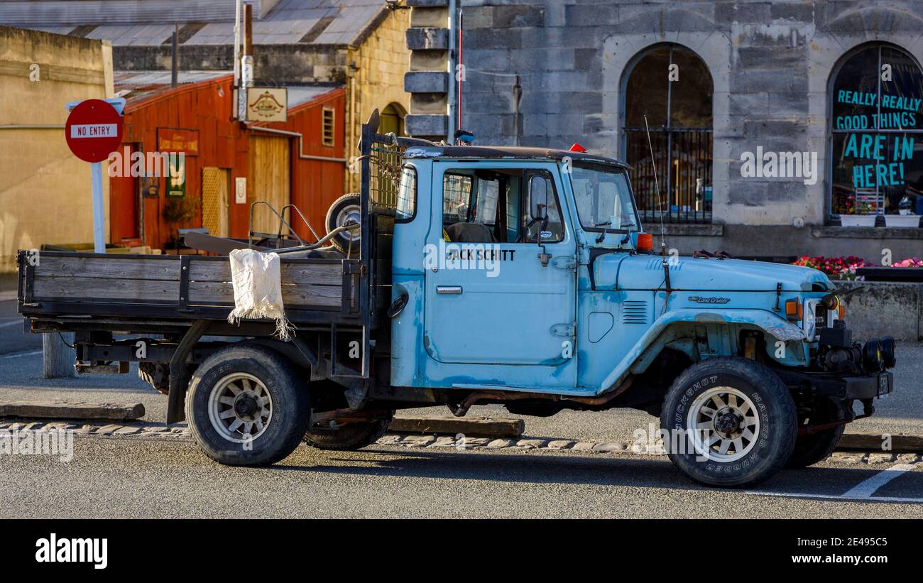 Toyota Land Cruiser pick-up. Old and heavily used, on a street in Oamaru, New Zealand. 'Jack Schitt' stencilled on the door. Stock Photo