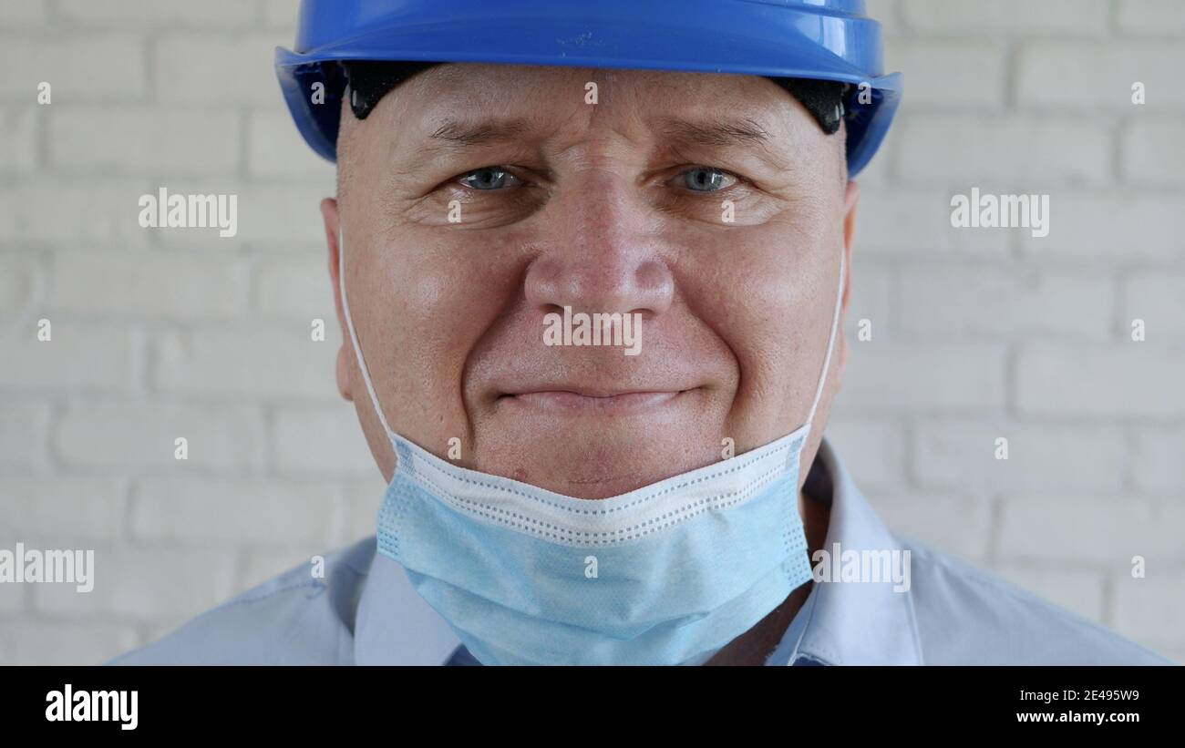 Confident Image with an Engineer Smiling and Wearing Face Protection Mask Against Viruses Stock Photo
