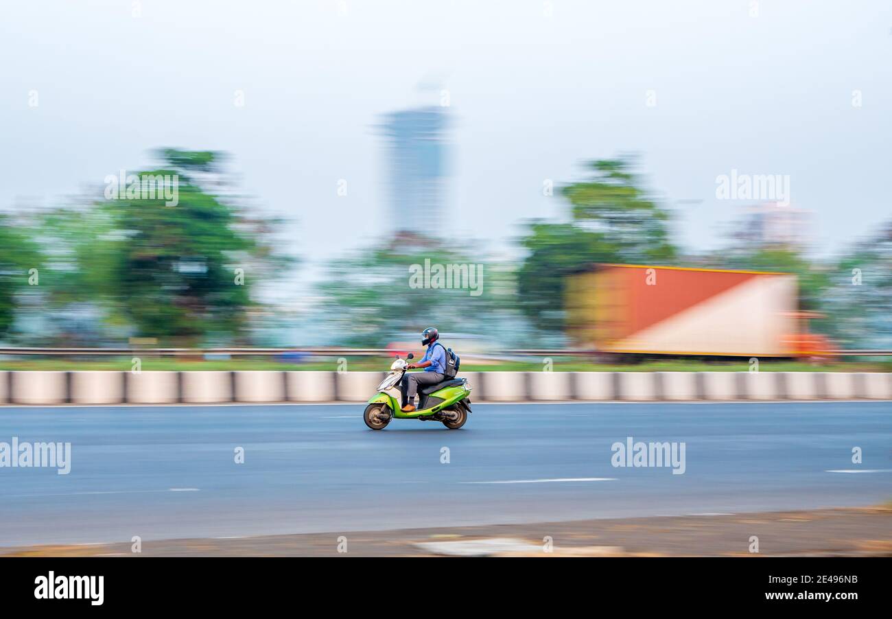 MUMBAI, INDIA - December 17, 2020 : Unidentified motorcyclist driving a two-wheel motorbike on streets of Mumbai Stock Photo