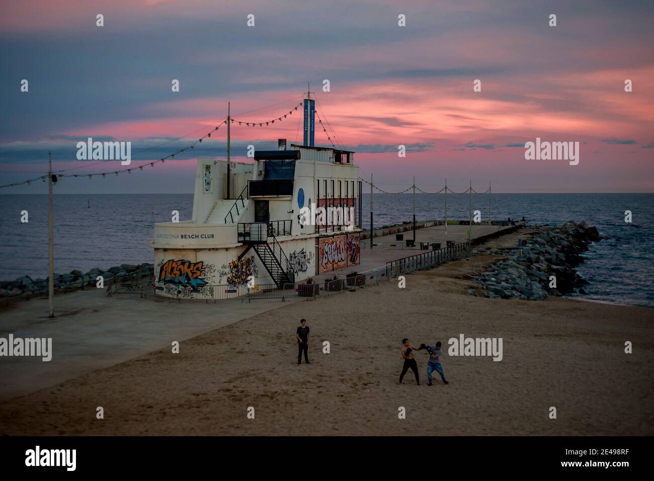 Young boys practise boxing in La Mar Bella beach of Barcelona close to a  closed and bricked up Boo Beach Club restaurant as the sun sets on January  21, 2021 Stock Photo - Alamy