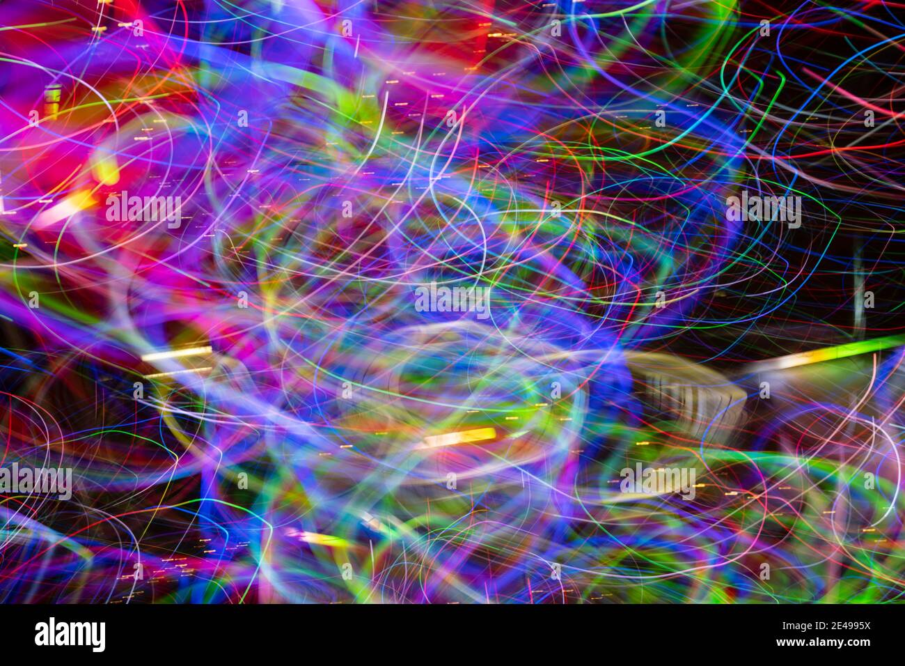 Layered spectrum of bright chaotic colors in light effect created by LED lights photographed outdoors at night. Stock Photo
