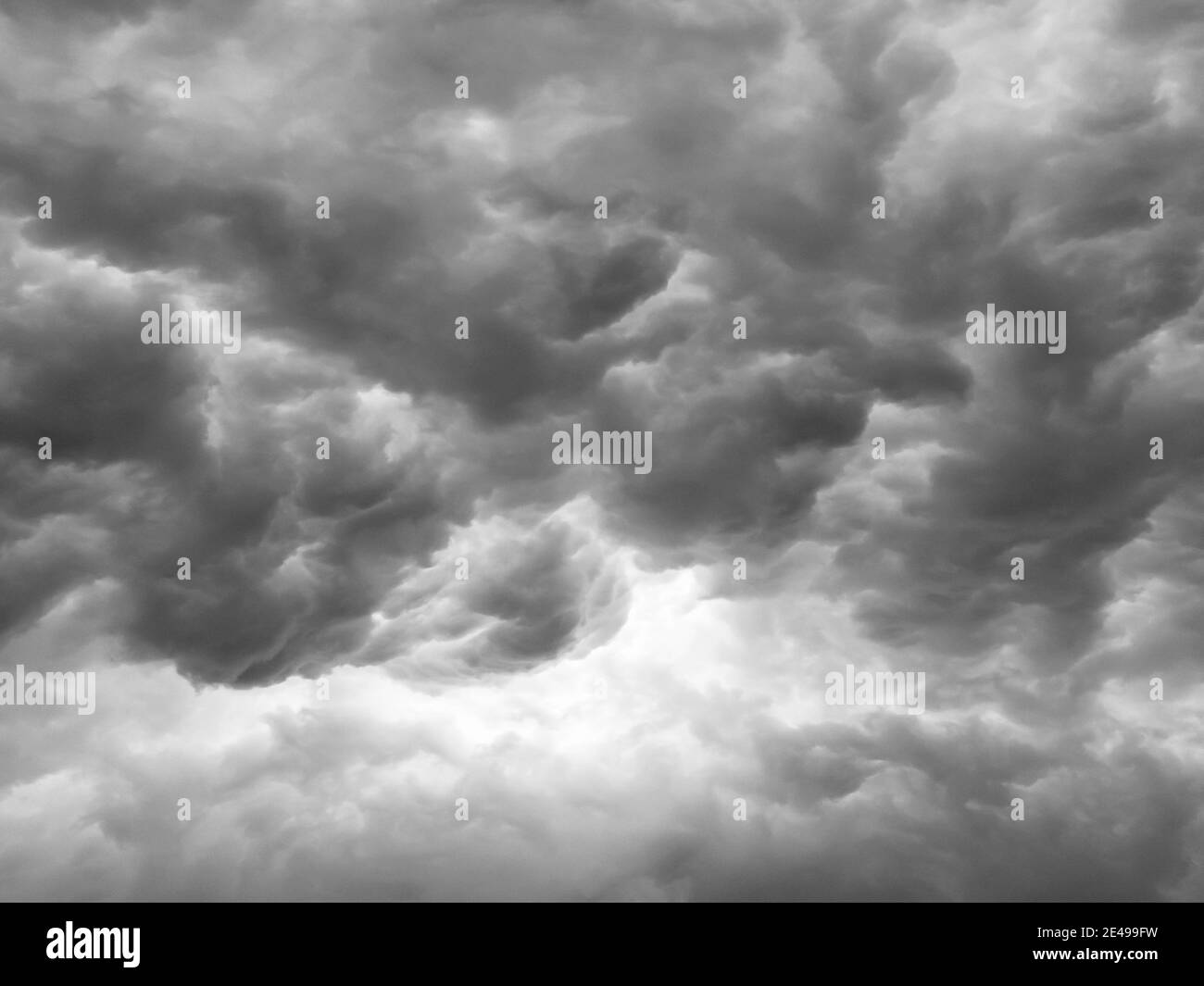 Black clouds formed before the rain. Ominous storm clouds. Sky before a thunderstorm. Used to make a background image. Stock Photo