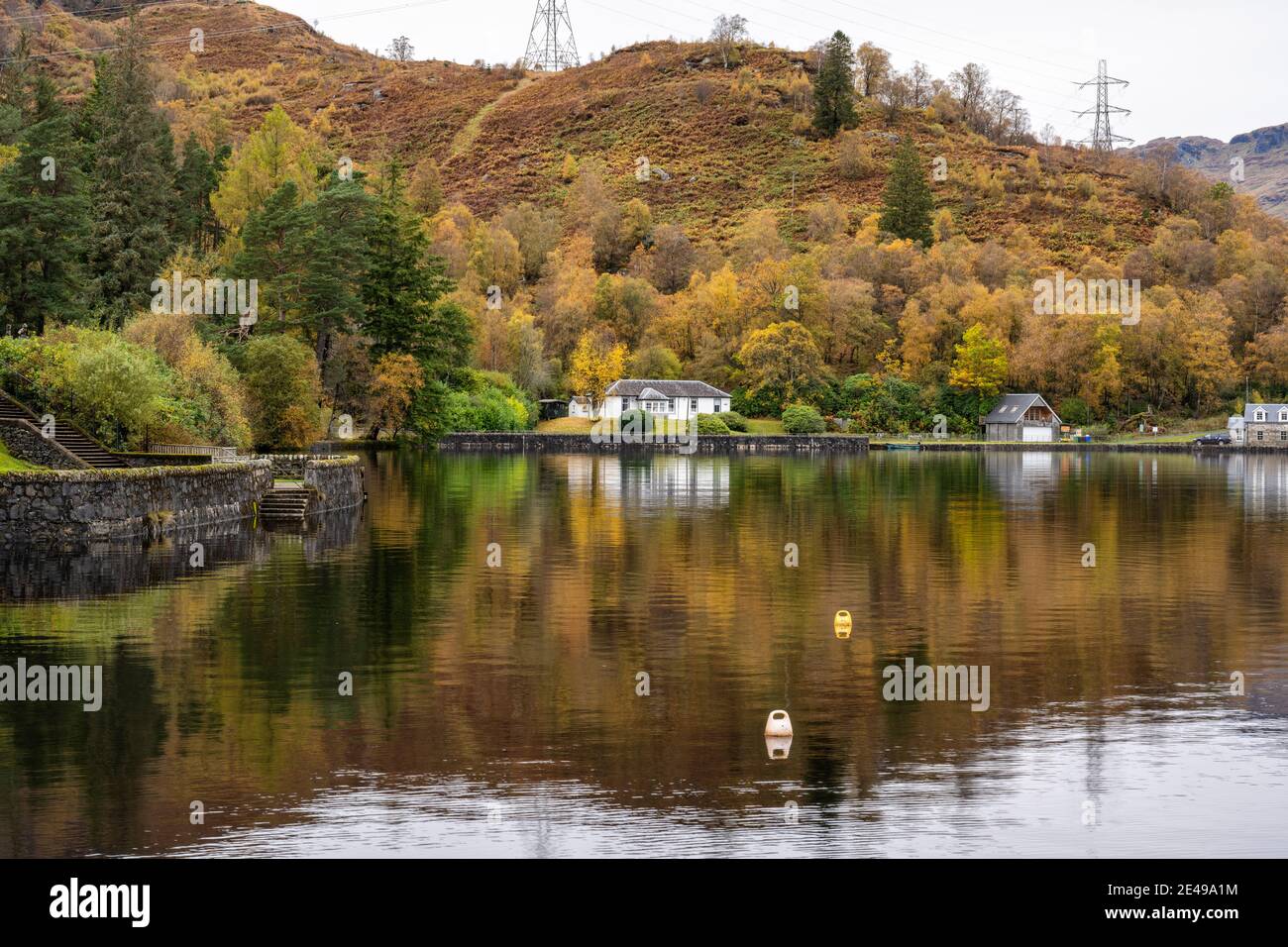 Autumn reflections Stronachlachar Village on Loch Katrine, Scotland, UK Stock Photo