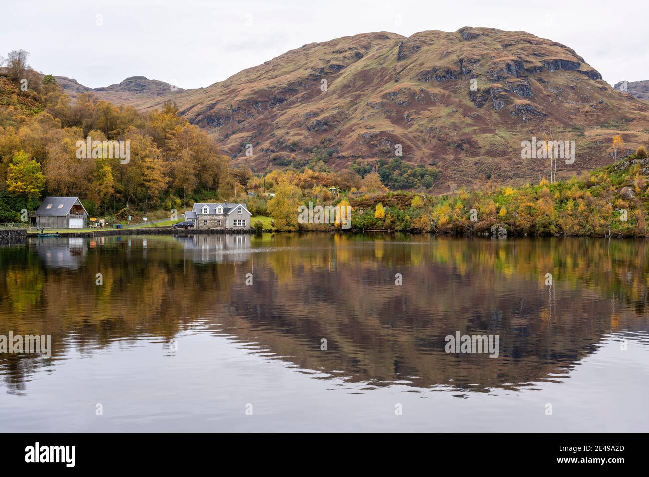 Autumn reflections Stronachlachar Village on Loch Katrine, Scotland, UK Stock Photo