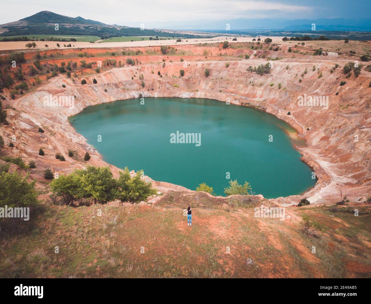 Drone view of woman traveler in font of copper mine Stock Photo