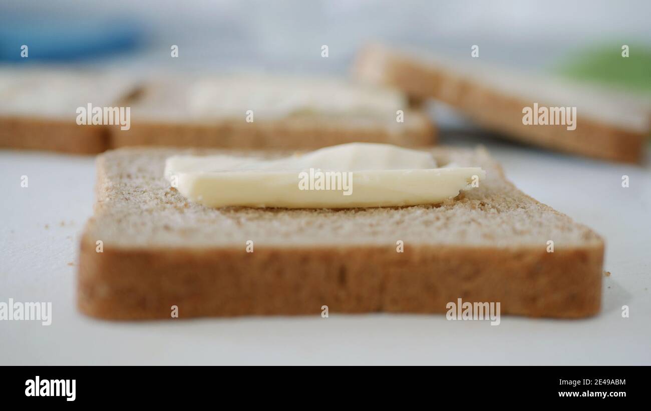 Morning Breakfast with Butter on the Toast. Spreading Margarine on a