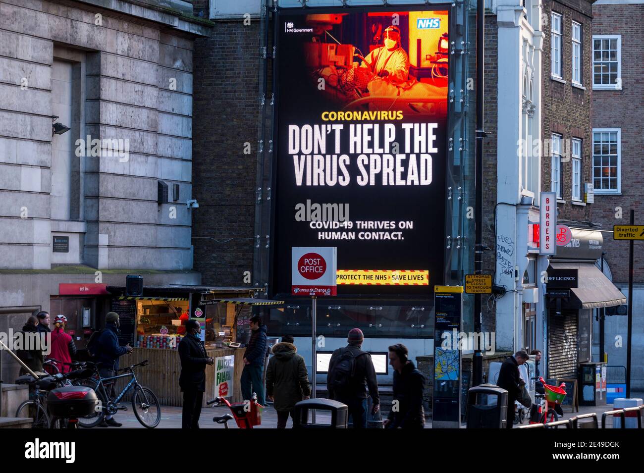 London, UK. 22 January 2021. A digital screen near London Bridge displays a  message by the UK Government warning the public about the dangers of the  ongoing coronavirus pandemic. The latest data