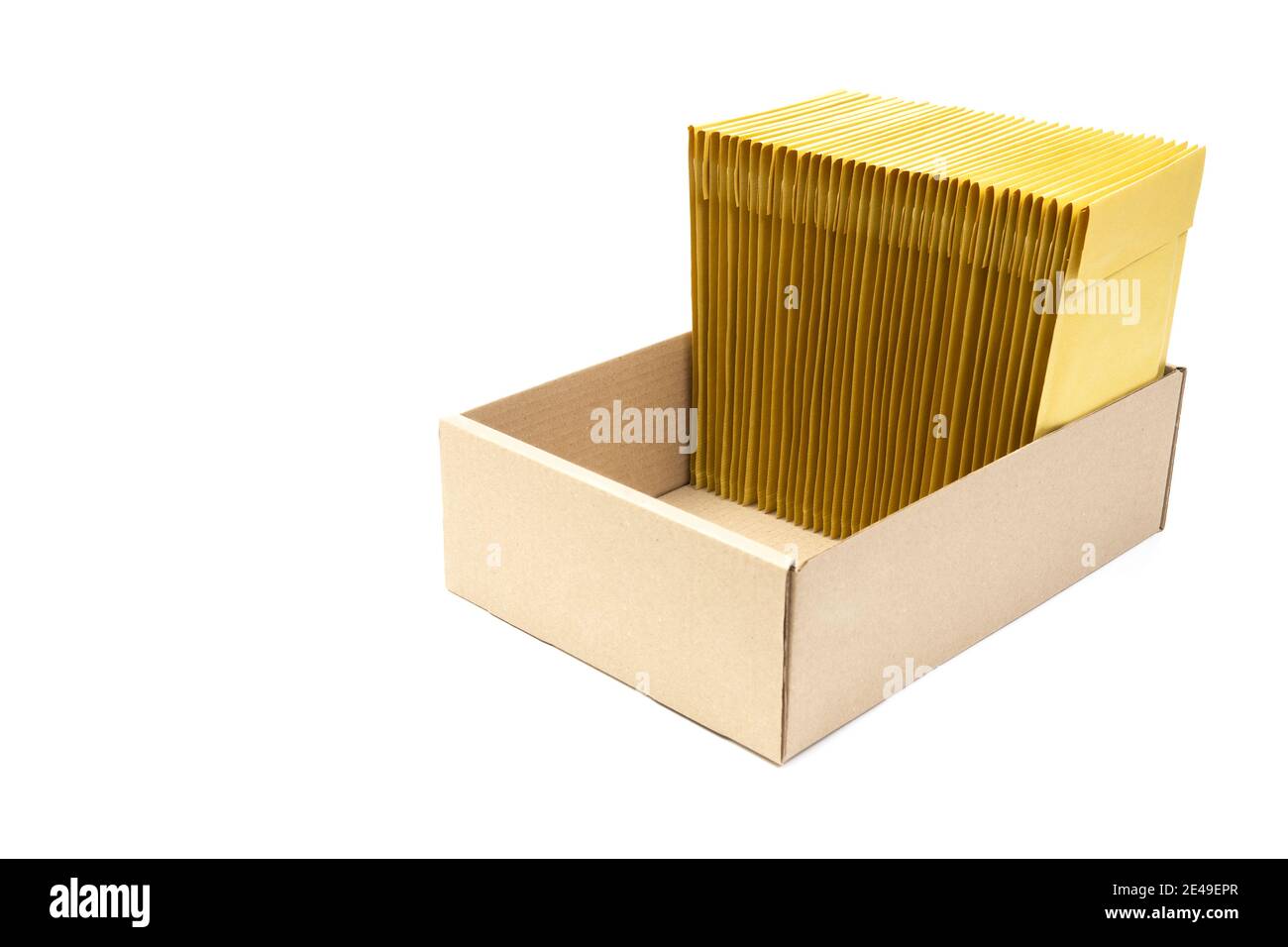 Vertical stack of yellow padded envelopes in a low cardboard box