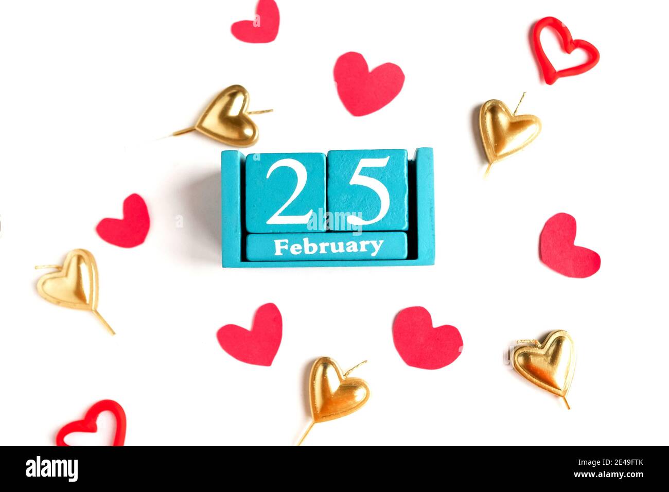 February 25. Blue cube calendar with month and date and decorative ...