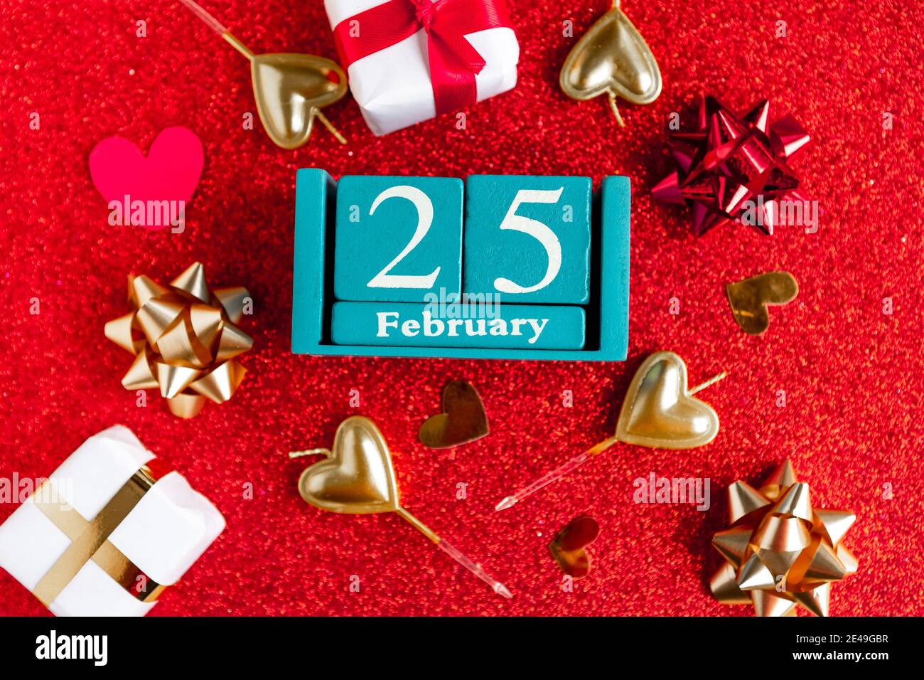 February 25. Blue cube calendar with month and date and decorations on ...