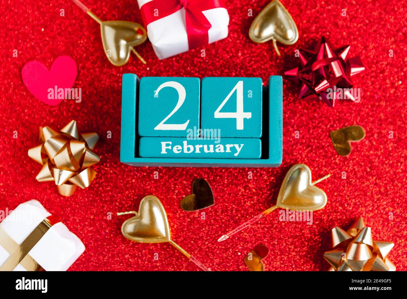 February 24. Blue cube calendar with month and date and decorations on ...