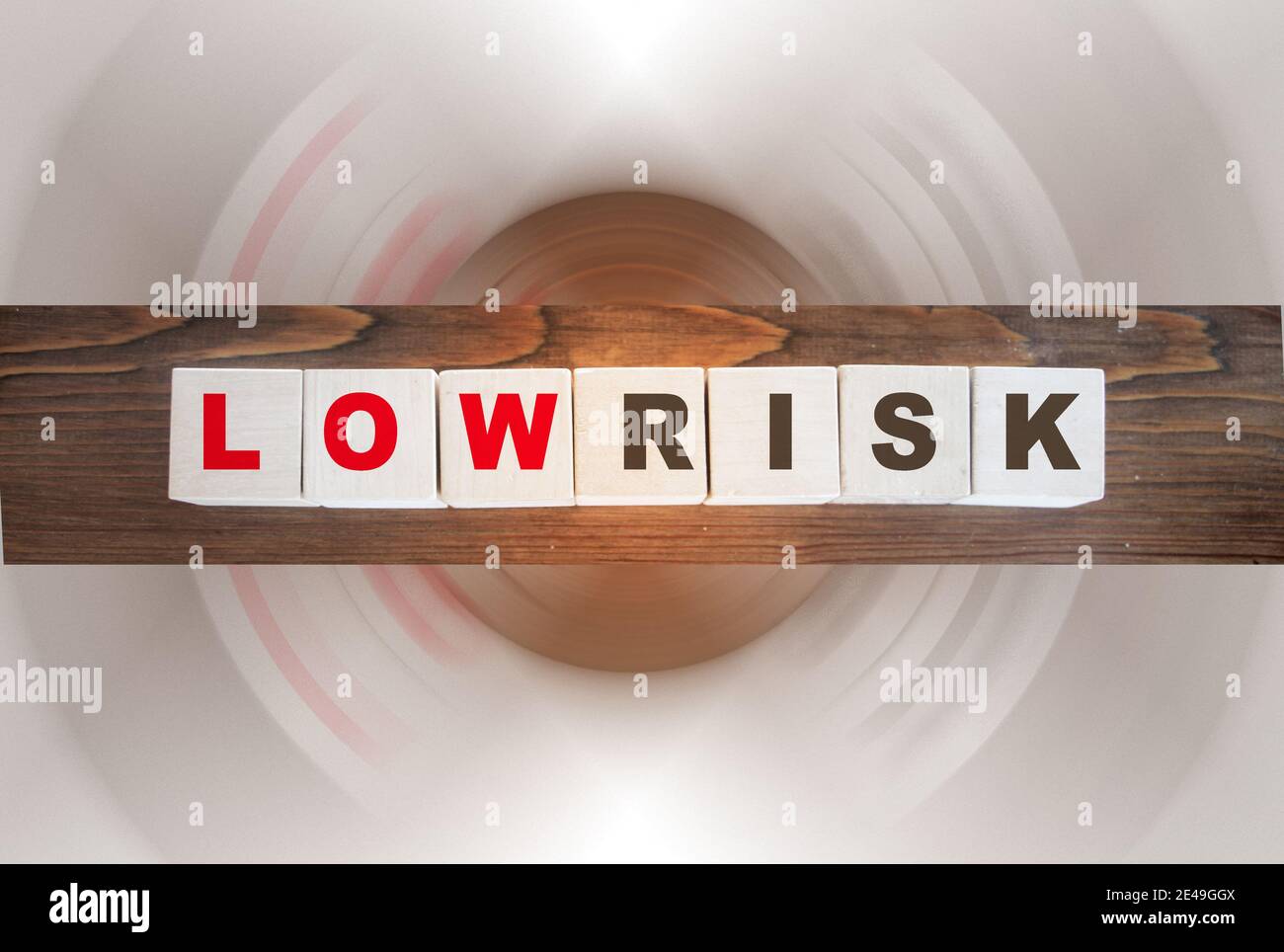Low risk words written on wooden cubes. Financial risk assessment, risk reward and portfolio risk management concept.. Stock Photo