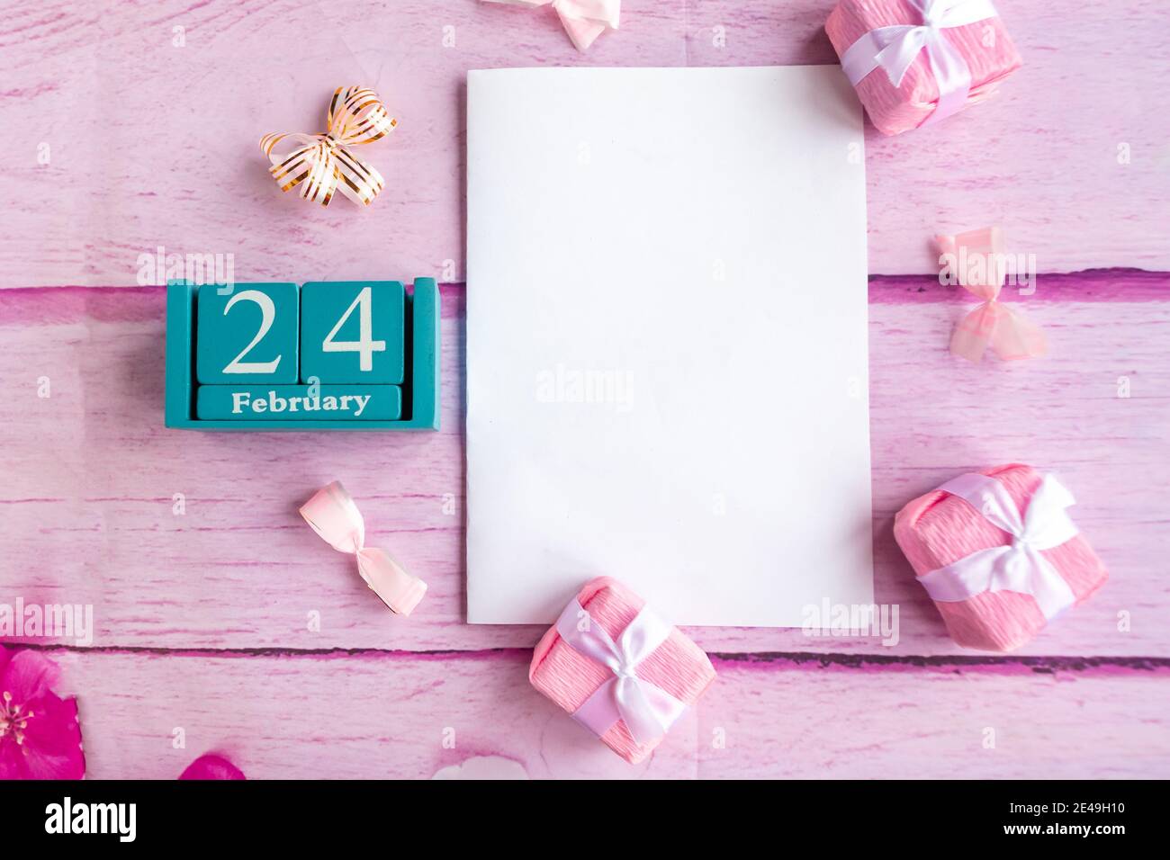 February 24. Blue cube calendar with month and date and white mockup ...