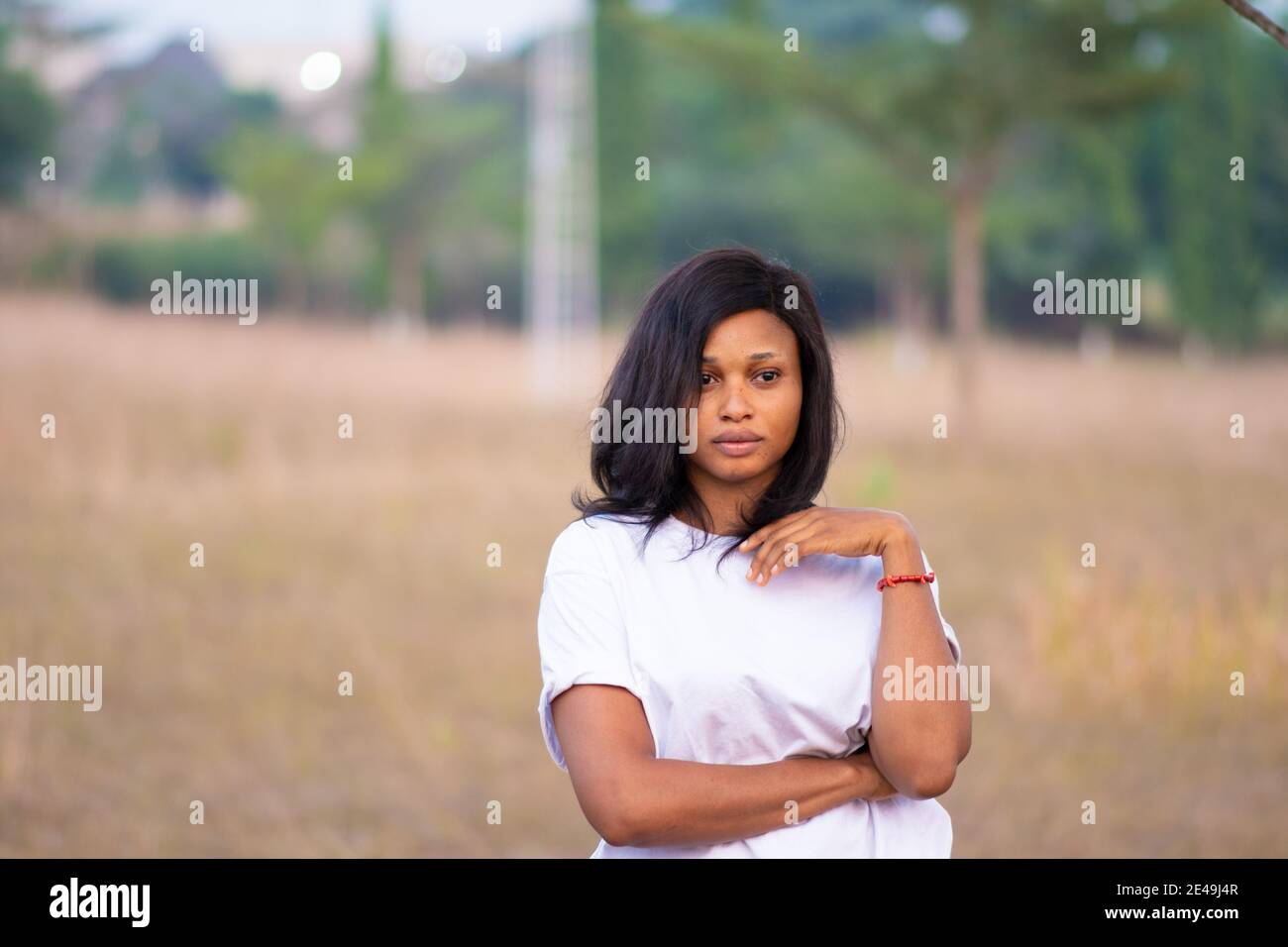 portrait of a young african woman standing in a park Stock Photo